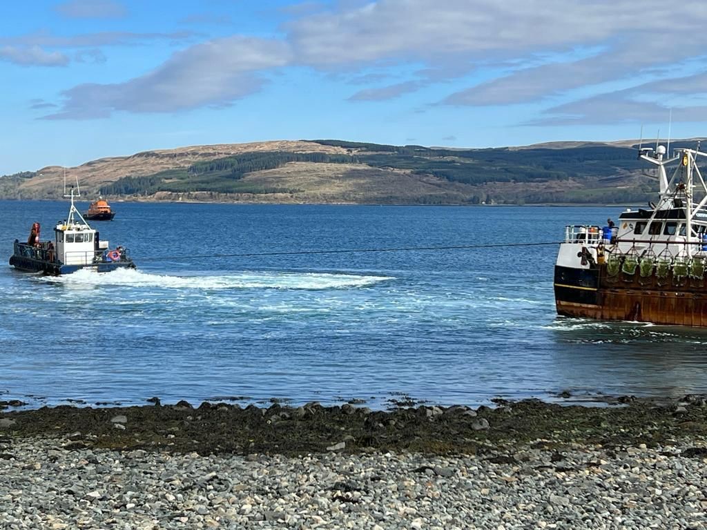 Fishing boat undergoing tow