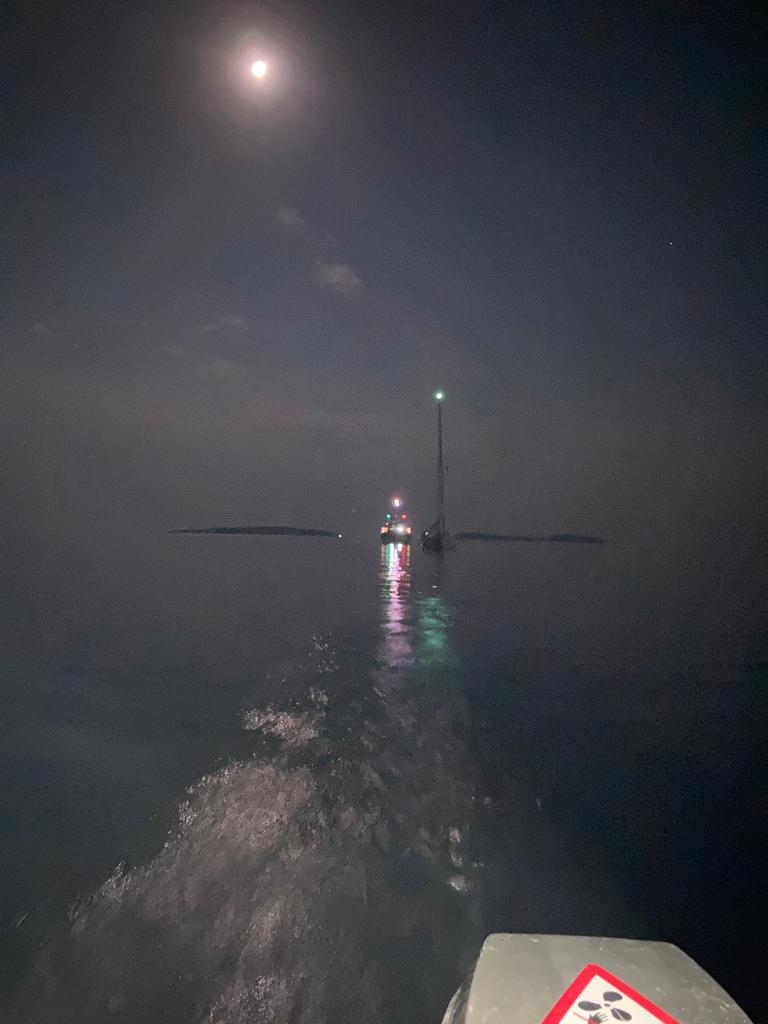 Moonlit shot of lifeboat alongside yacht