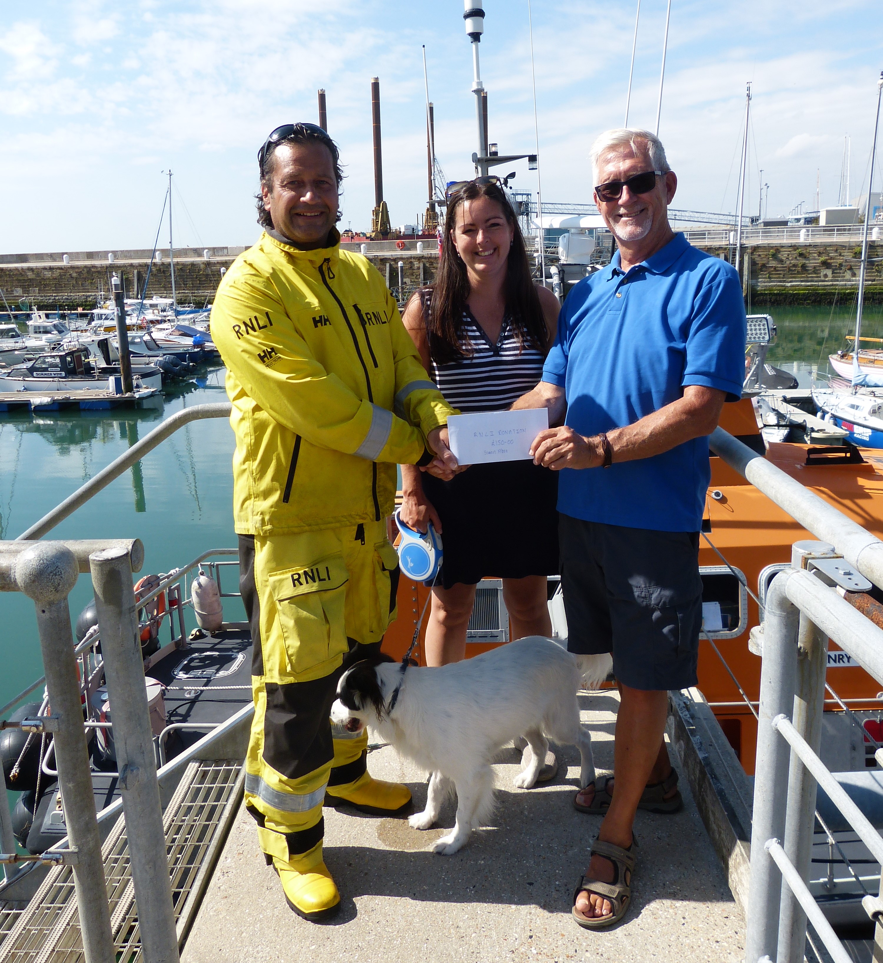 A lifeboatman being presented with a cheque.