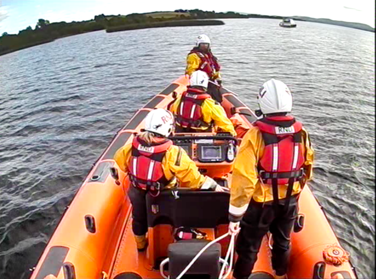 Four crew looking ahead at the casualty vessel aground on a shoal
