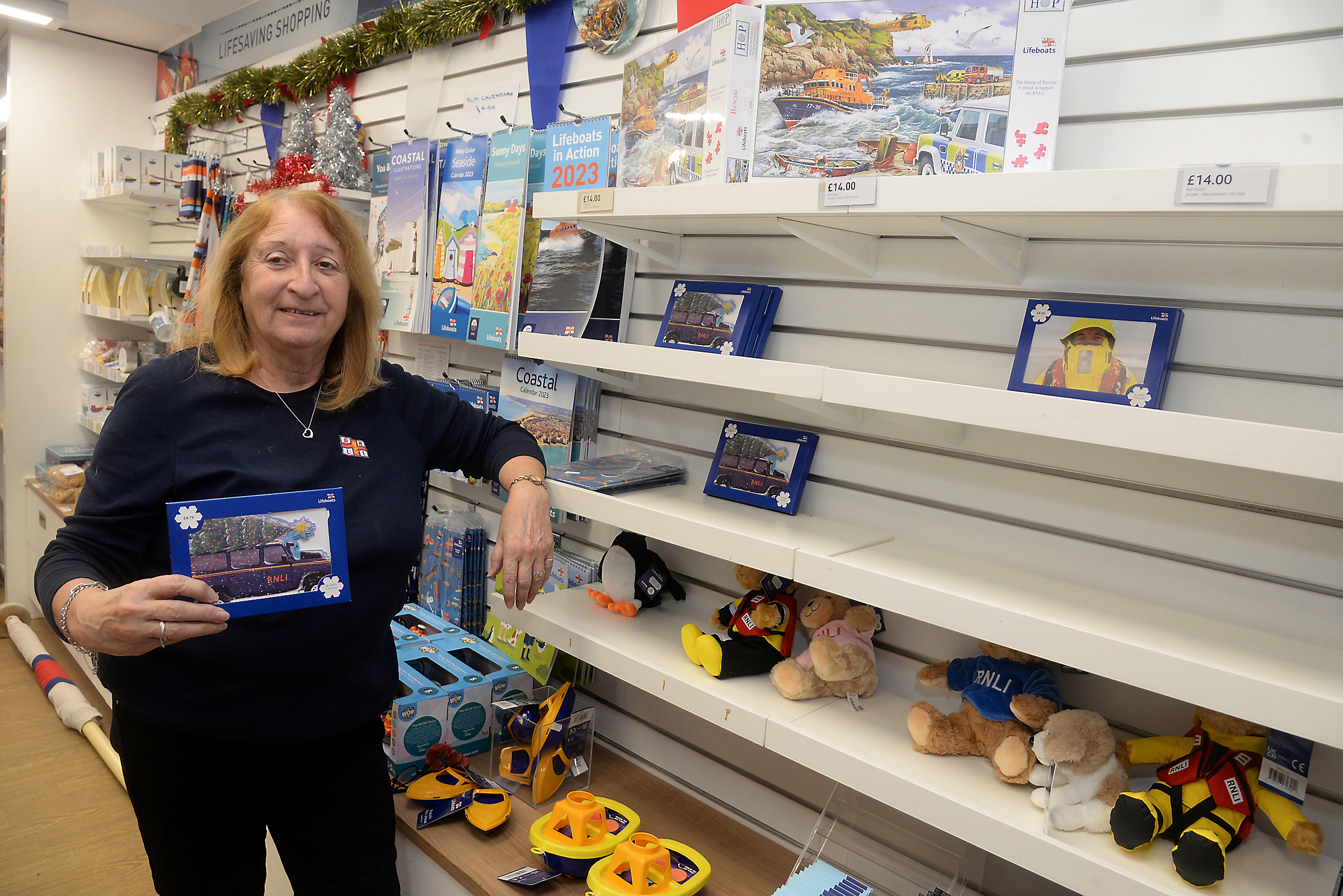 Shop volunteer Anne-Marie Kean with the almost empty shelves that contained Christrmas cards after a busy weekend in the RNLI shop at Whitstable on Sunday.