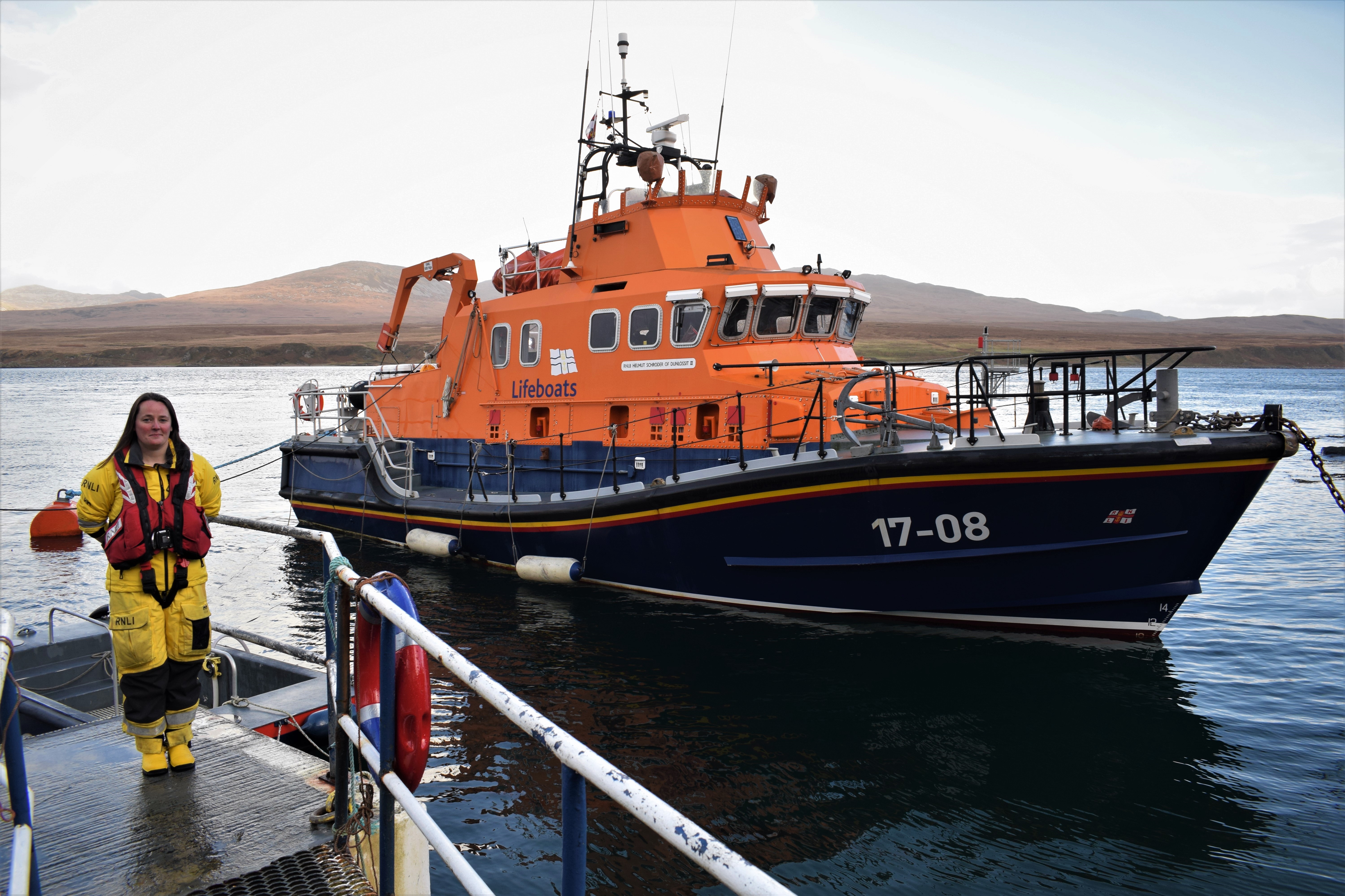 Cara stands proudly beside the lifeboat she could take command of this Christmas.