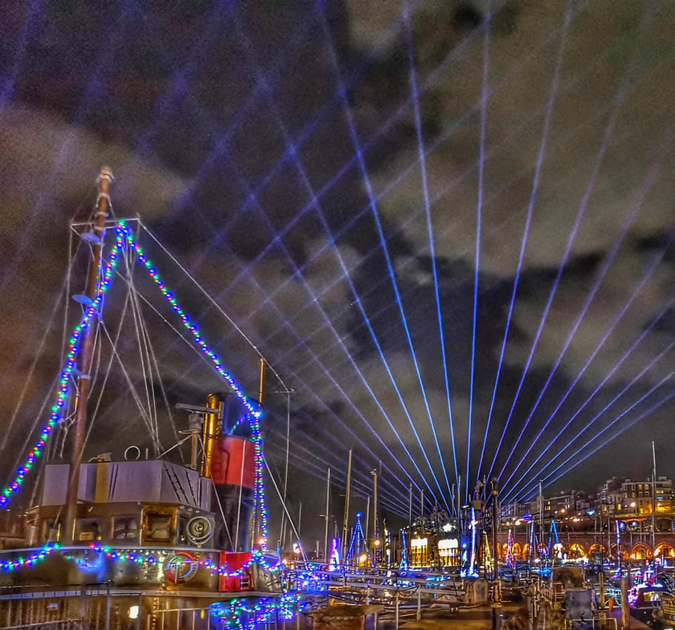 Various boats and buildings part of the Ramsgate Illuminations events. Lights cast their shine over the sky