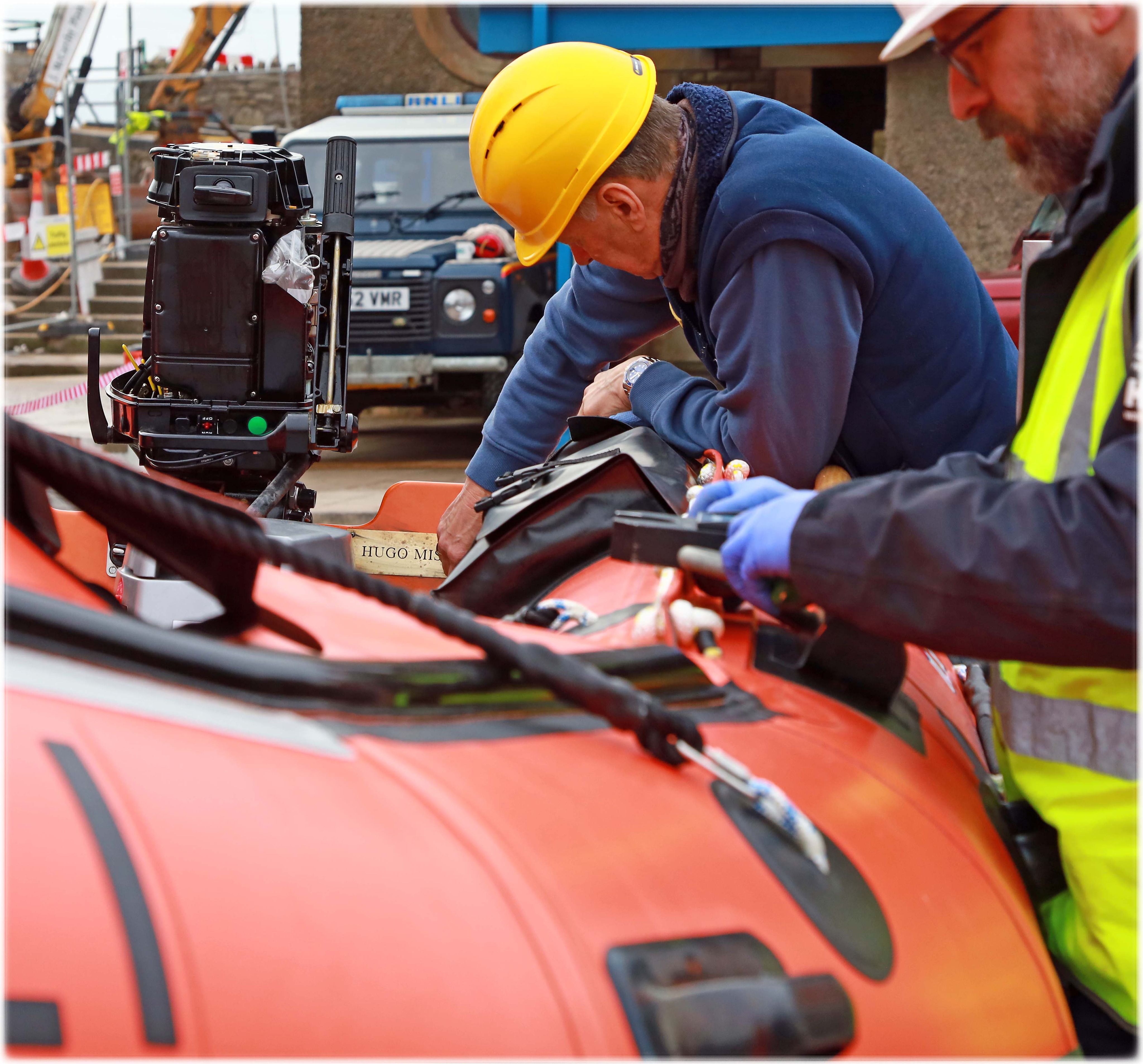 The Lifeboat Operations Manager, Philip Missen polishes the name plaque on D861 Hugo Missen