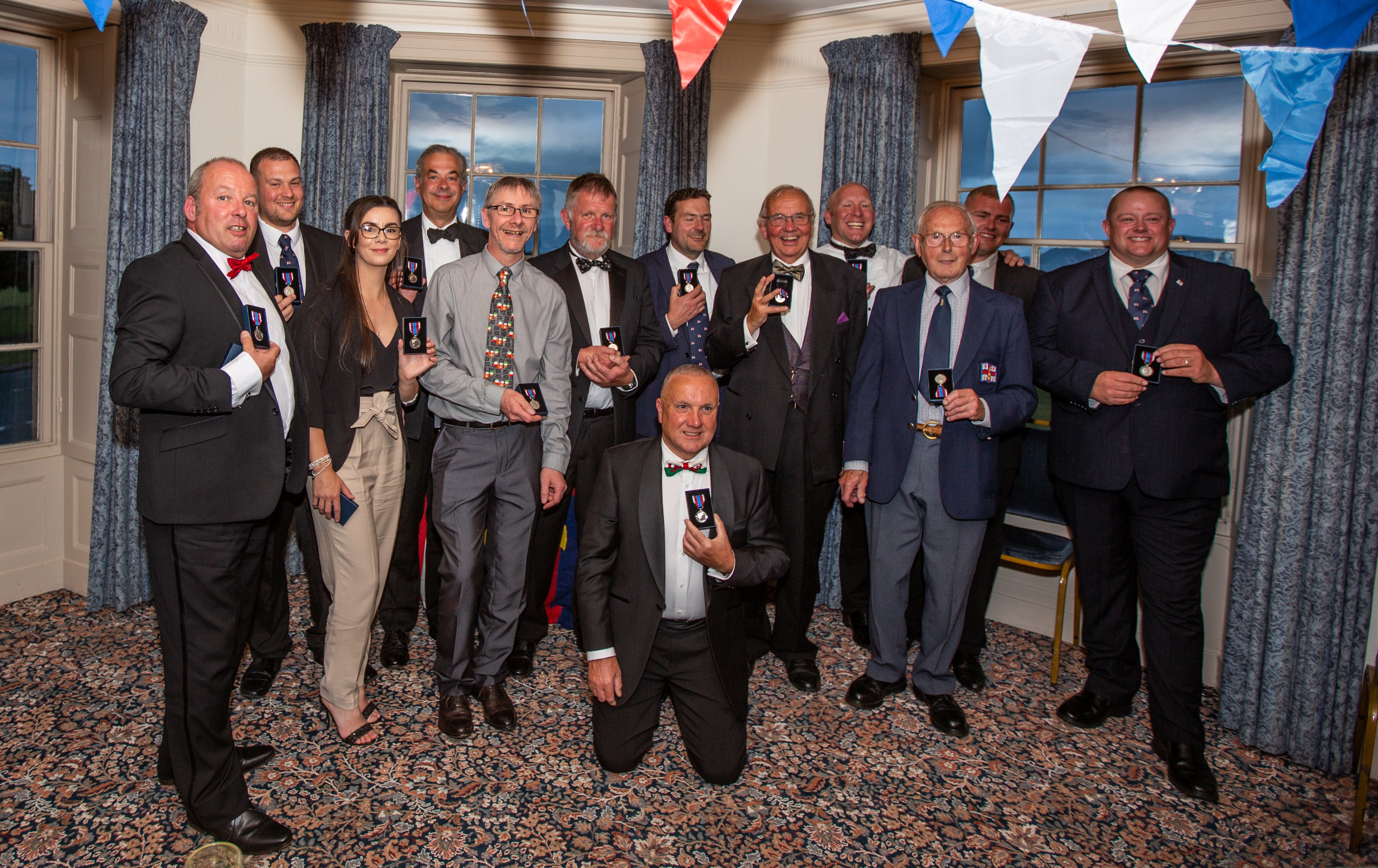 The volunteers who could attend on the night with their Queens Platinum Jubilee medals.