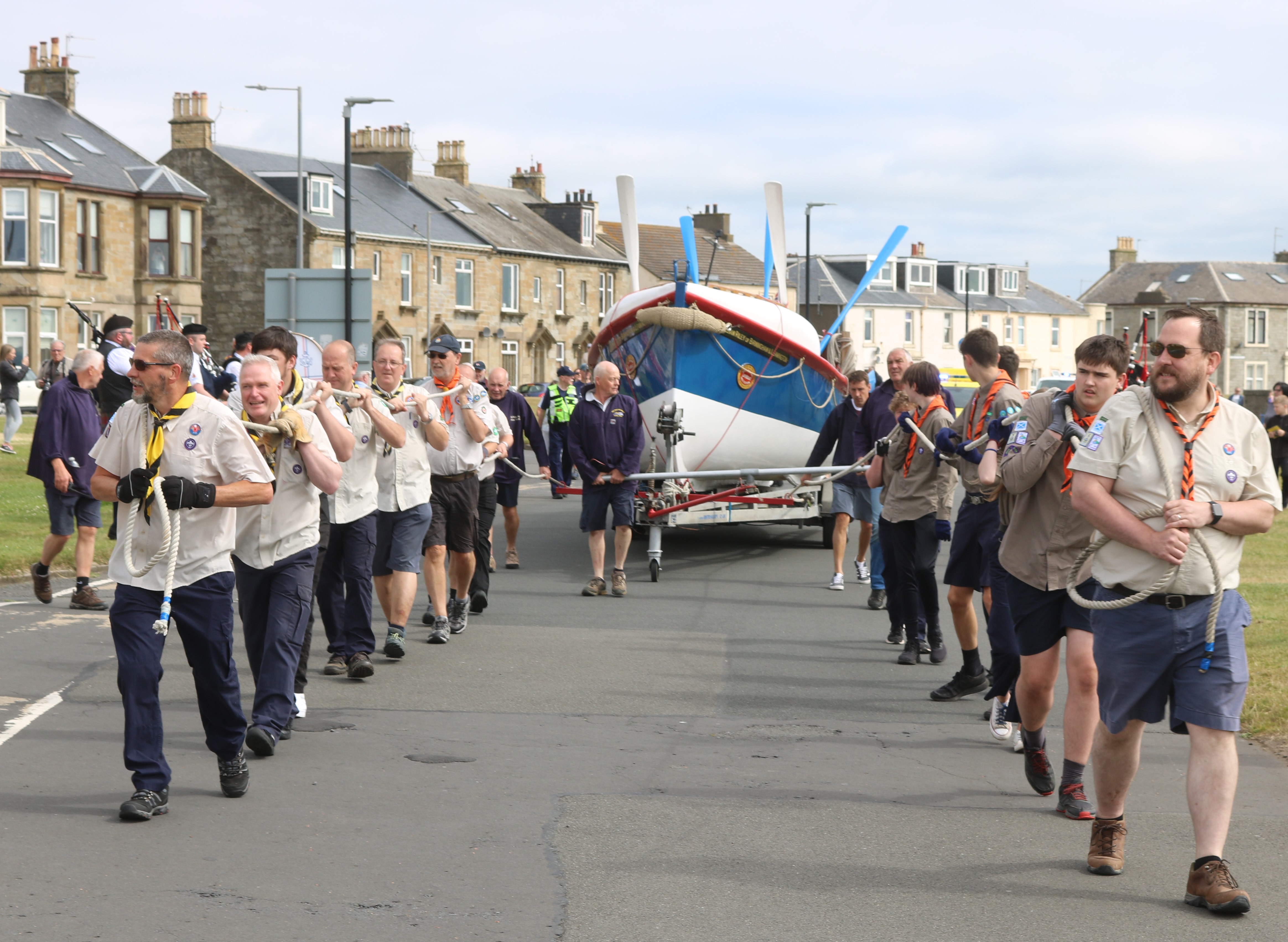 Scouts and other youth groups pulling the William Riley Lifeboat along the esplanade