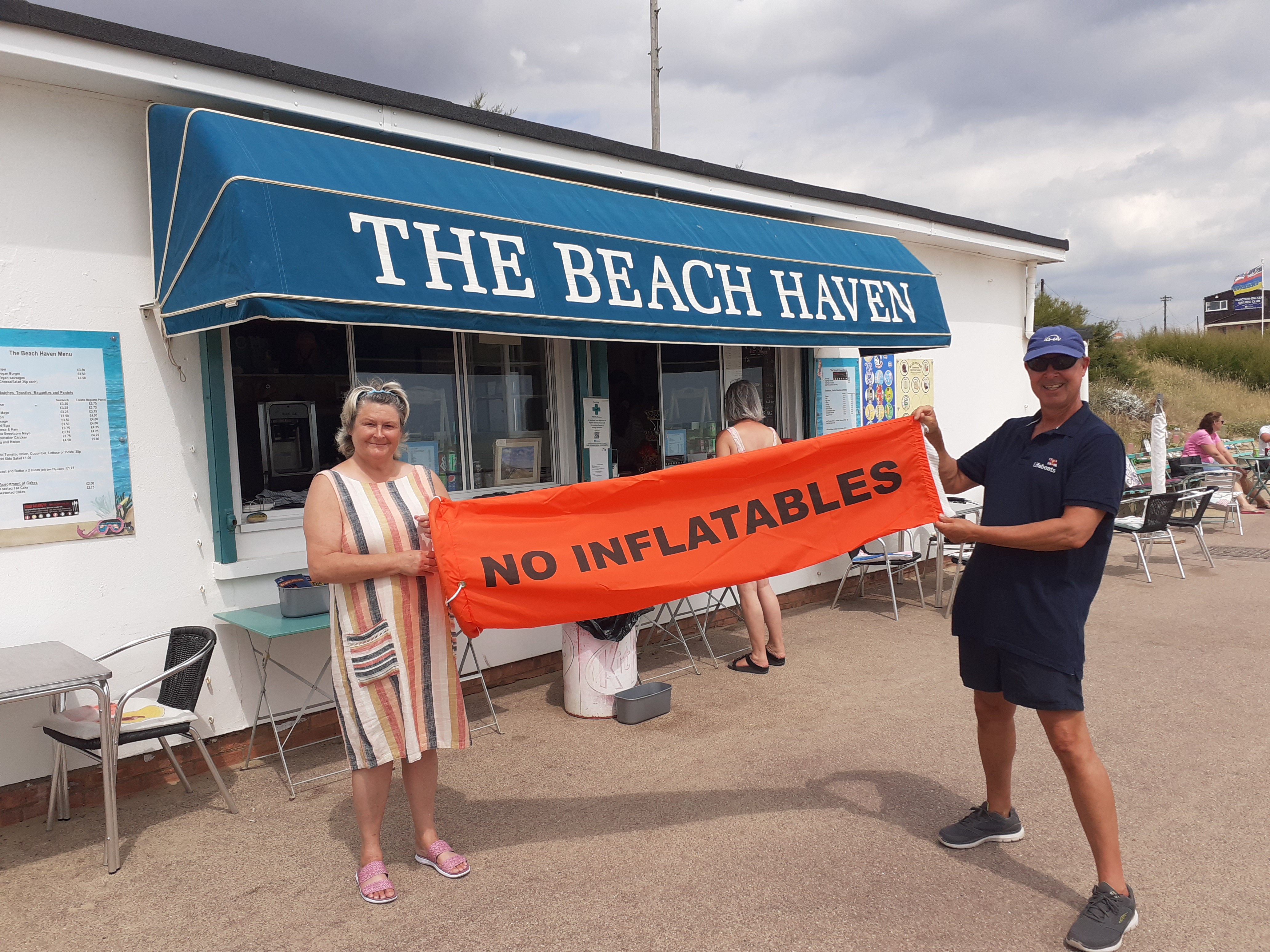The RNLI orange windsock flying outside The Beach Haven Cafe