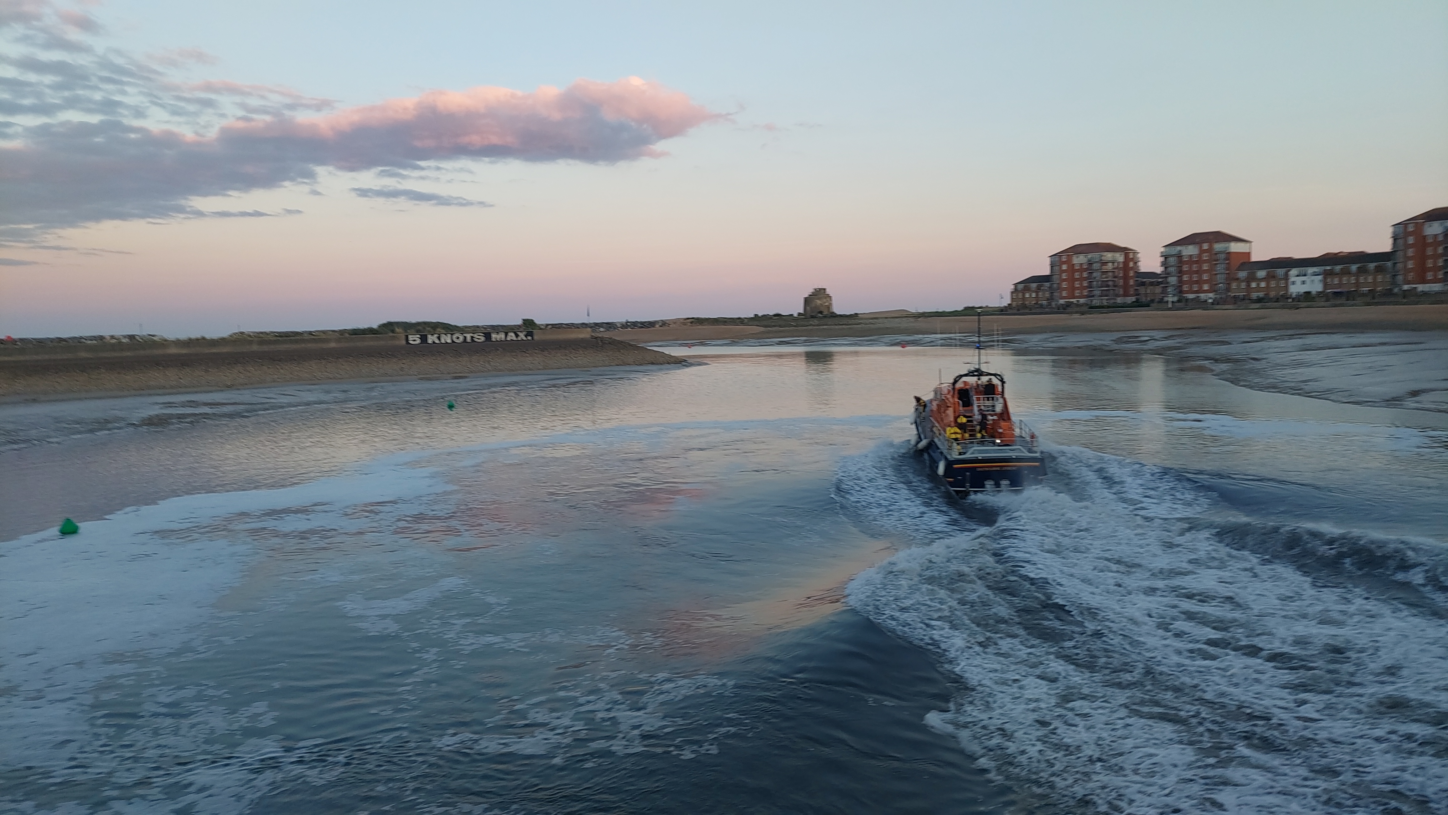 Lifeboat leaving the harbour at sunset