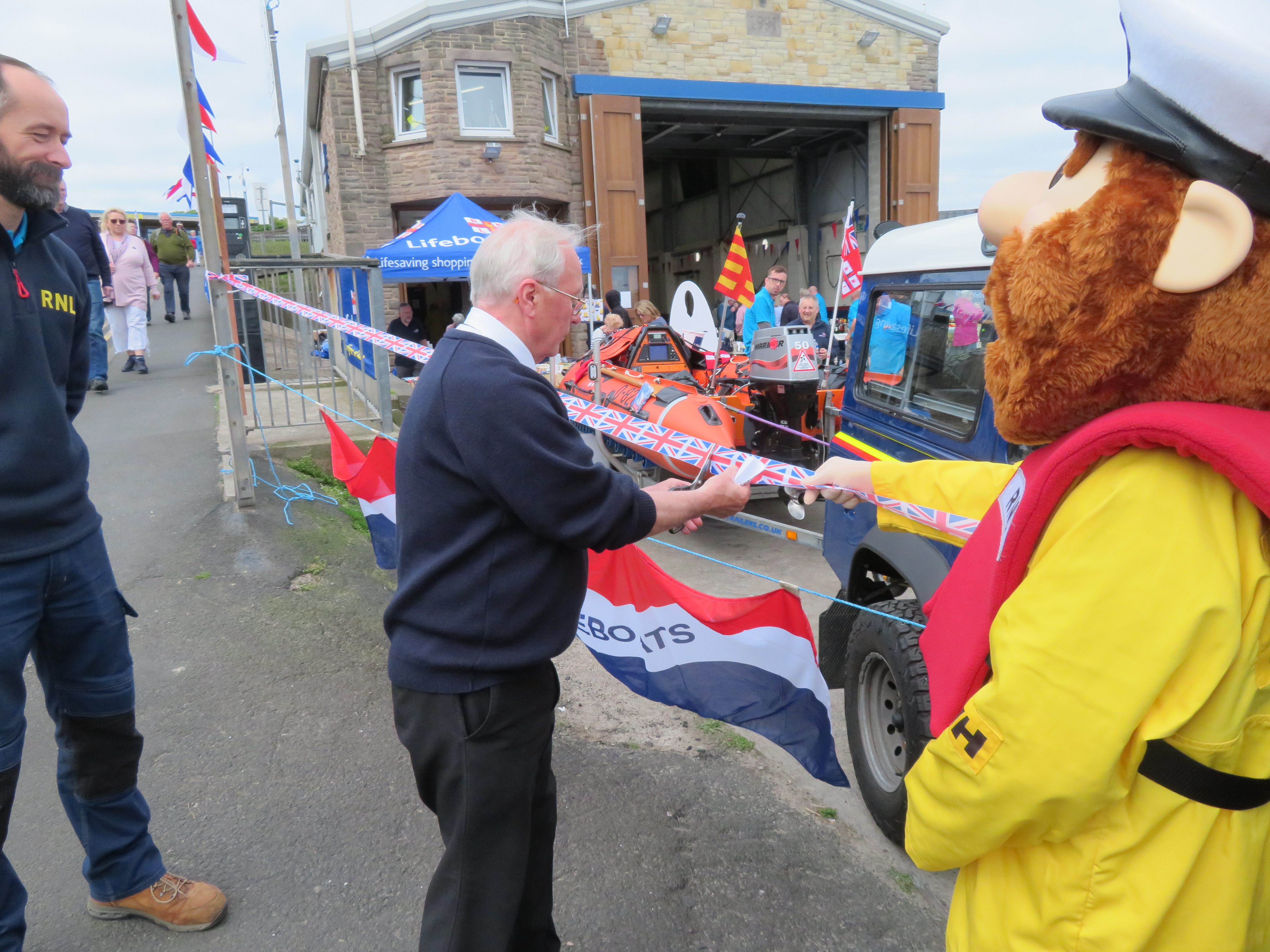 Harbour Master Brian Wilson cuts the ribbon to open the fete