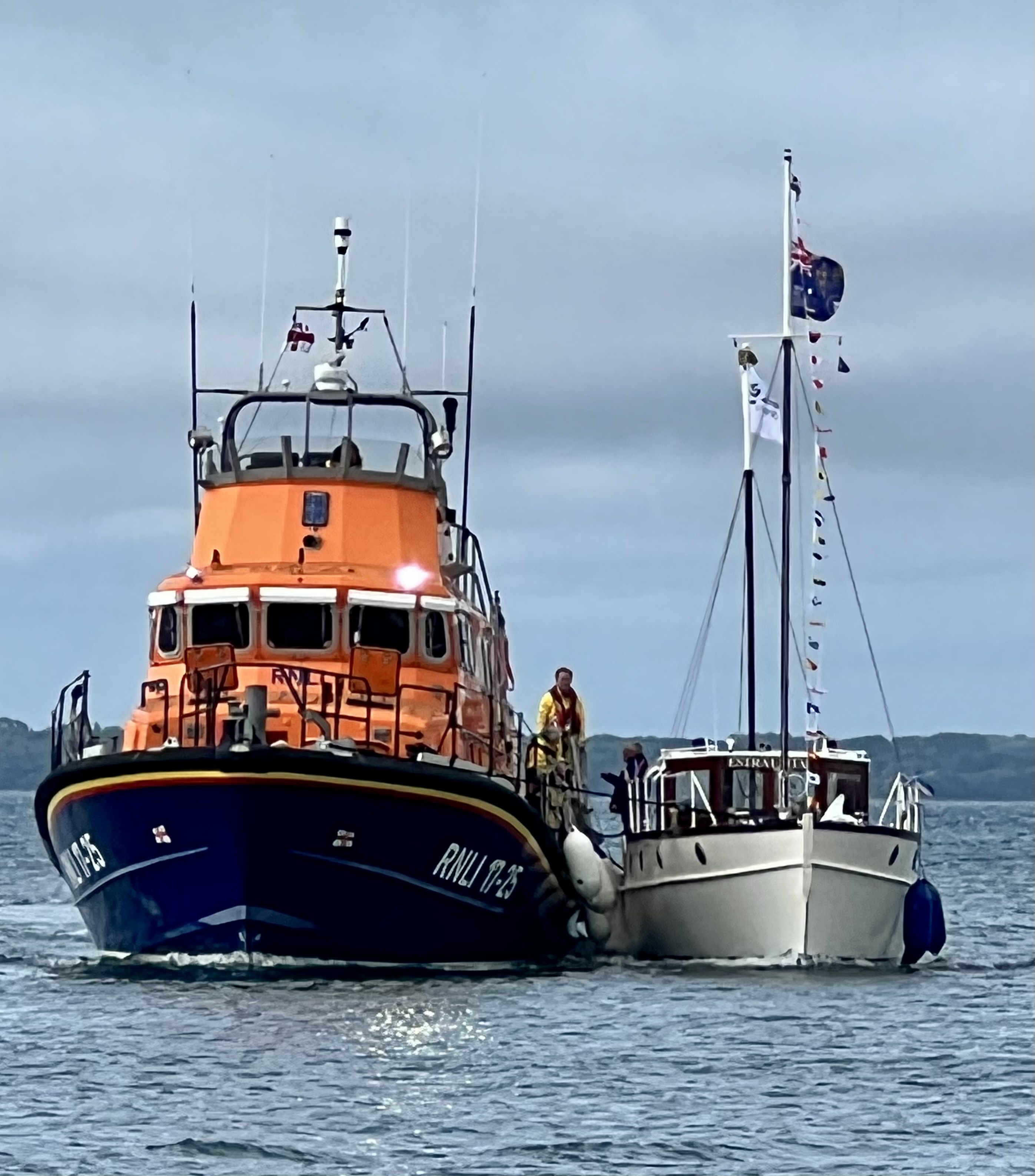 Yarmouth RNLI LIfeboat Eric and Susan Hiscock (Wanderer) returning to harbour with motor yacht alongside