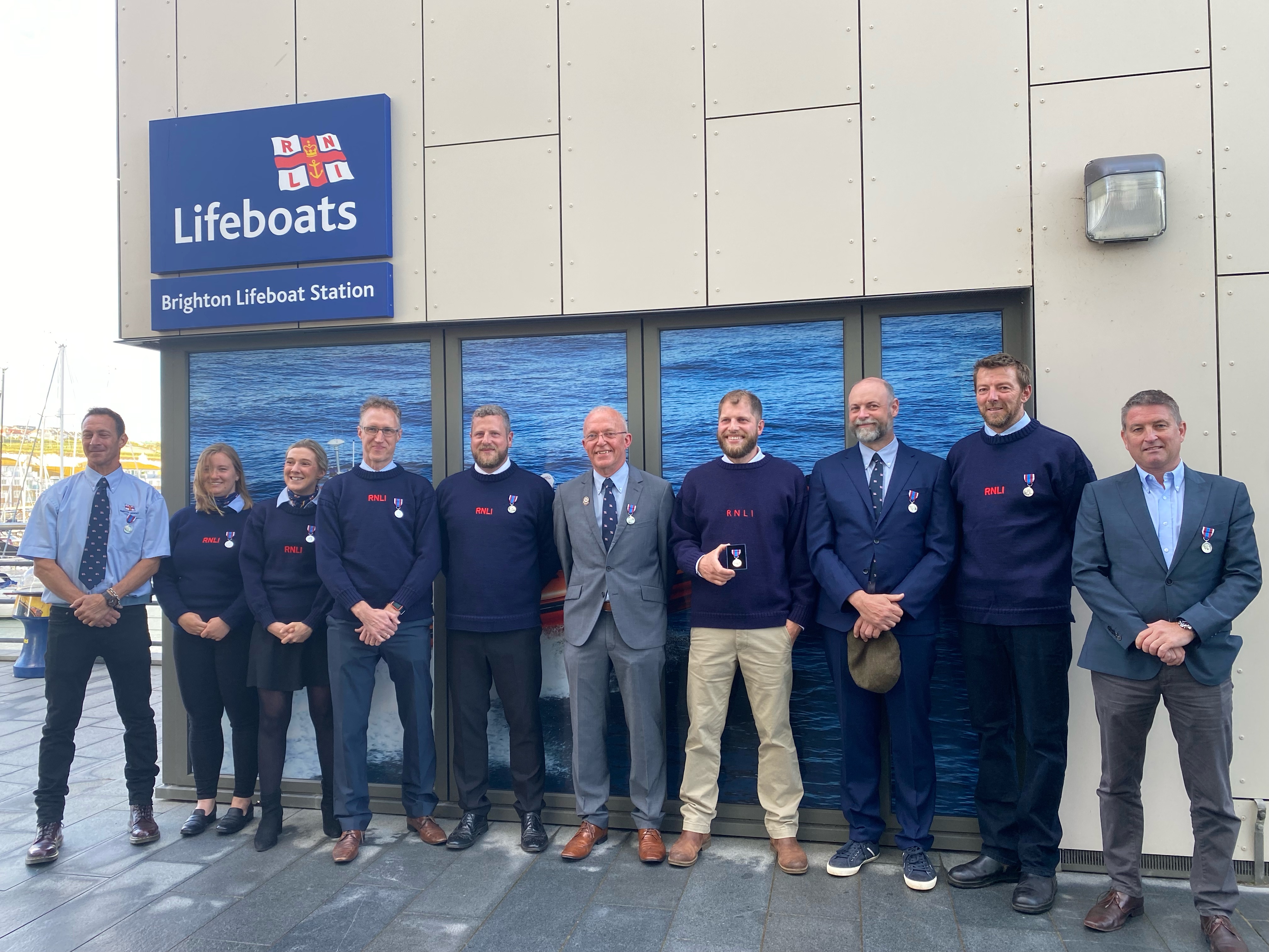 Ten RNLI volunteers posing with their medals