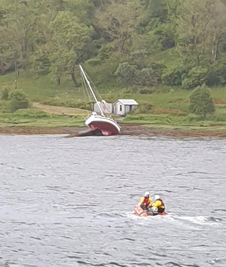 Y boat approaching yacht aground in Loch Aline