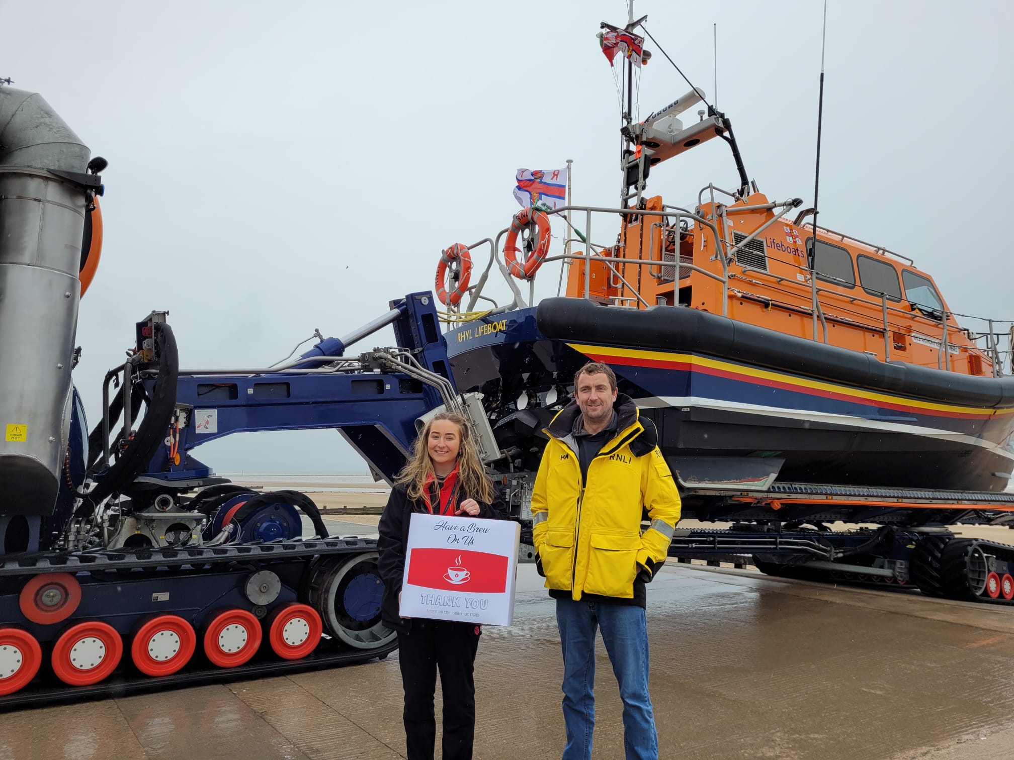 Acting Rhyl coxswain Andy Wilde receives donation of coffee machine for the station