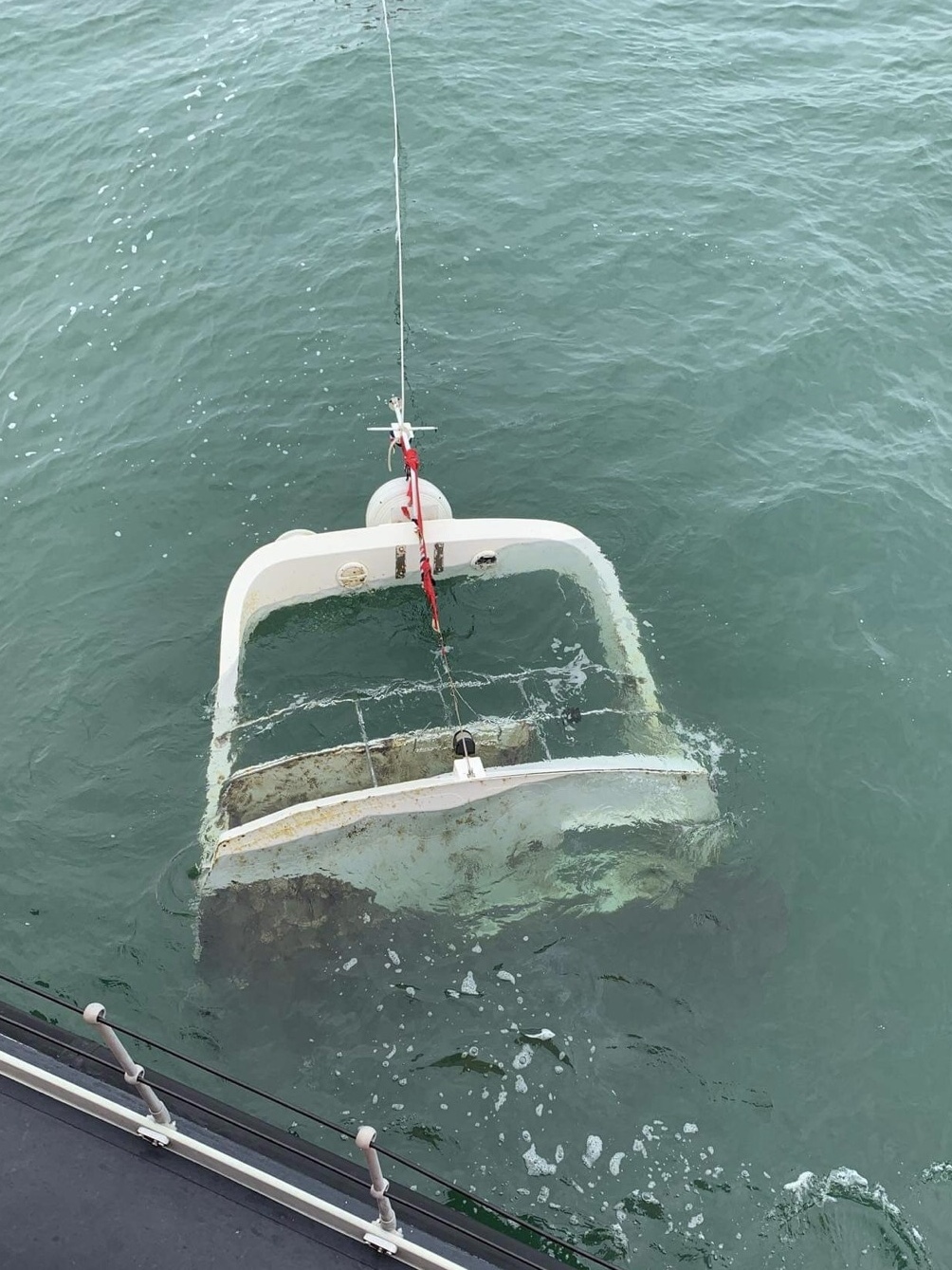 A flybridge of a motor cruiser partially submerged in the sea