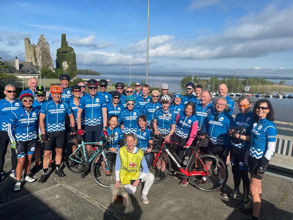 A group of clyclists and an RNLI fundraiser in a group photo at Lough Derg Yacht Club