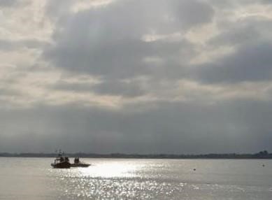 Photo of lifeboat assisting broken down speedboat in the distance