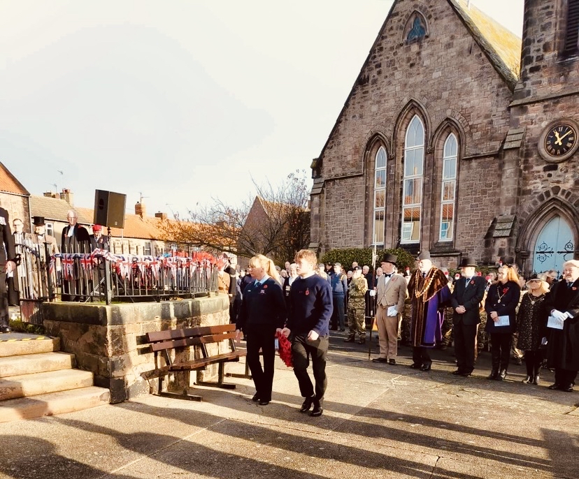 Berwick-upon-Tweed RNLI Crew Members Jack Mavin &amp; Hazel bettison getting ready to lay wreath at War Memorial