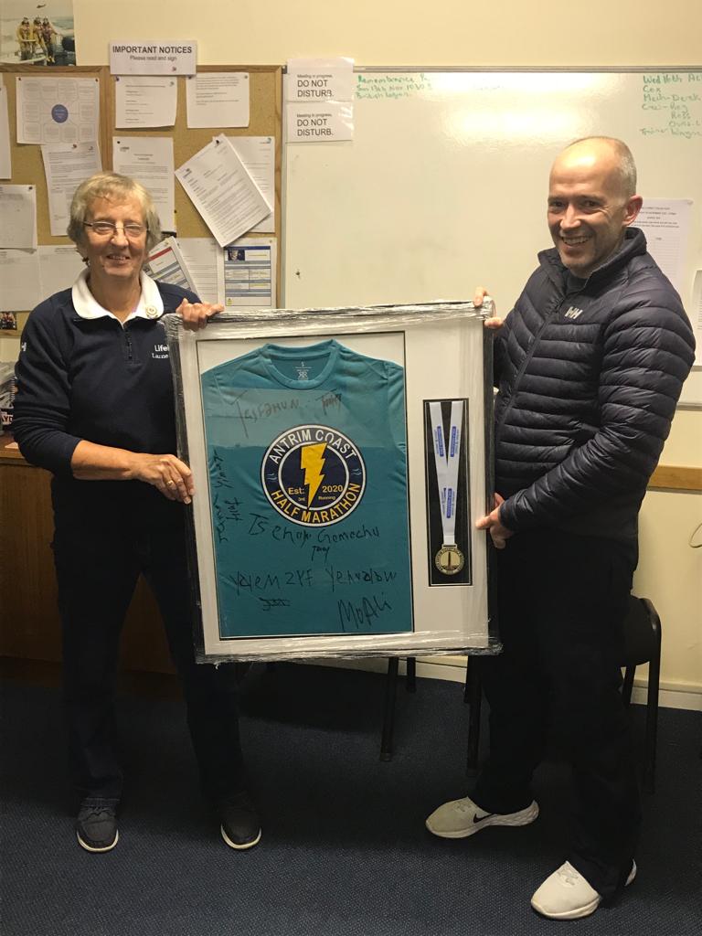 Barry Kirkpatrick receiving his commemorative shirt from Esther Dorman, Larne RNLI's fundraising secretary