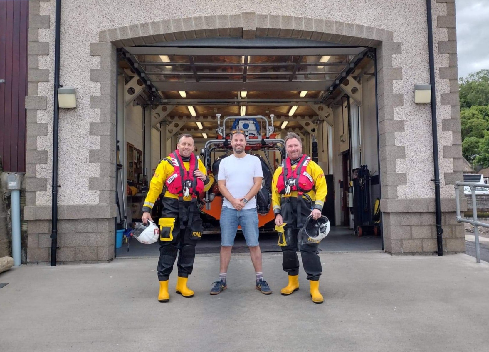 Graham Price with volunteer crew members Chris and Graham in front of Queensferry Lifeboat Station