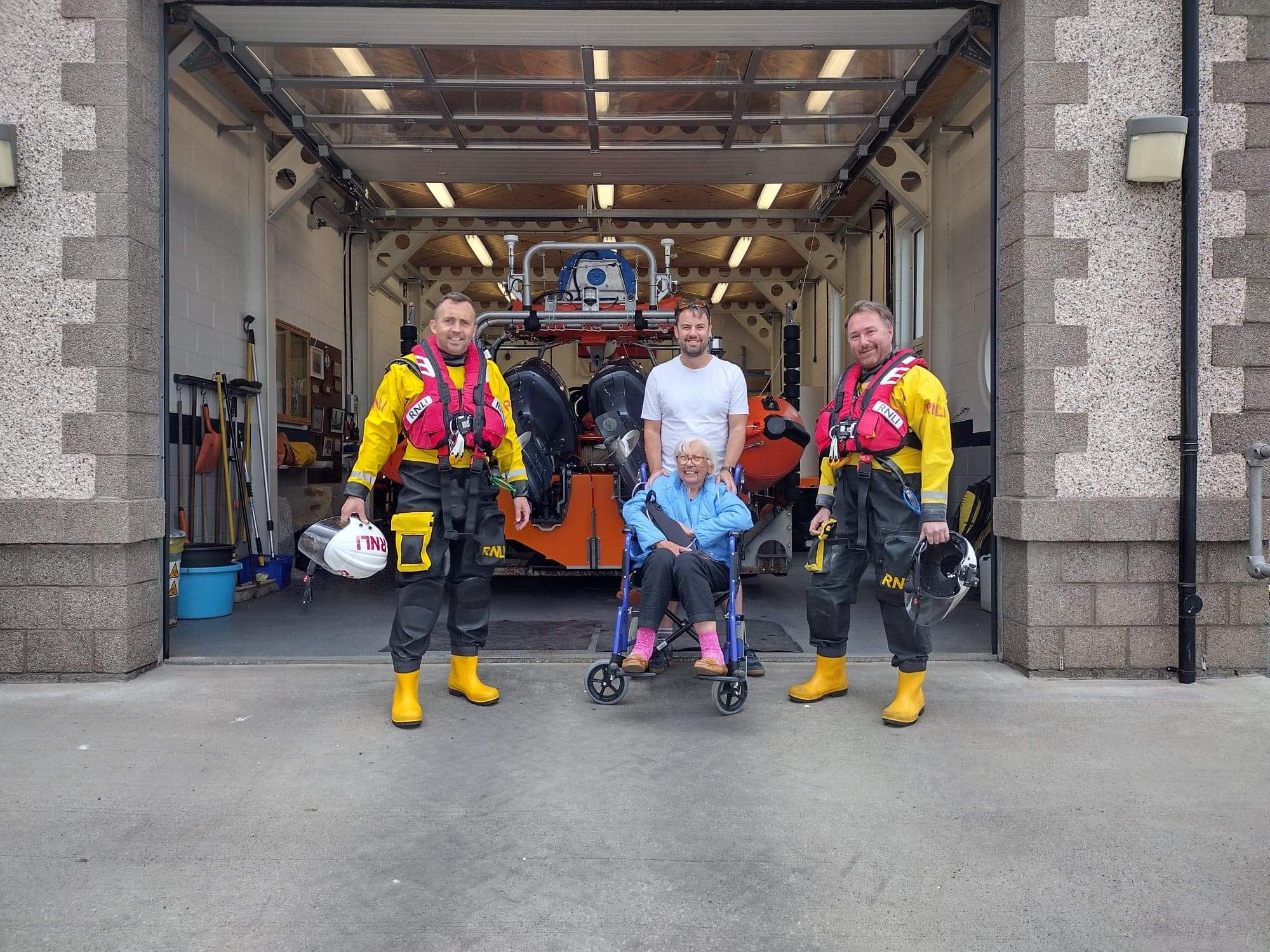 Graham and Mary Price with volunteer crew members Chris and Graham in front of Queensferry Lifeboat Station