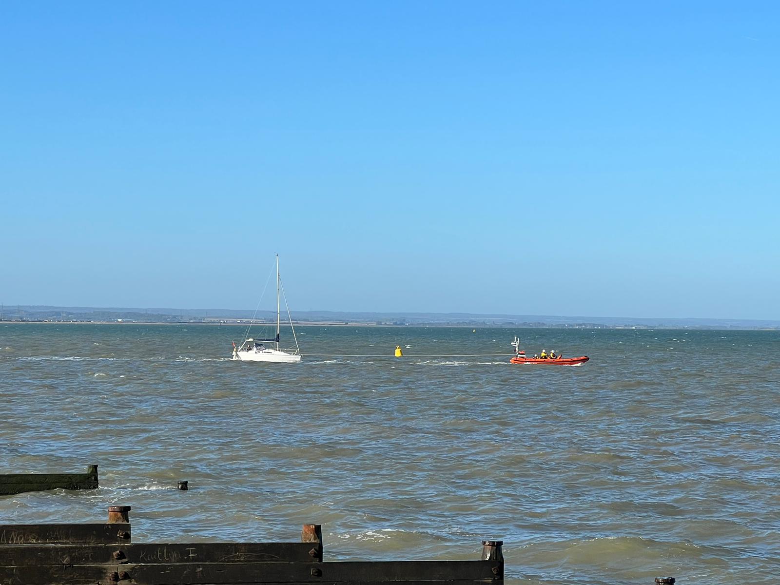 The 30-ft yacht under tow by the Whitstable RNLI lifeboat after going aground on the beach at Whitstable on Saturday morning