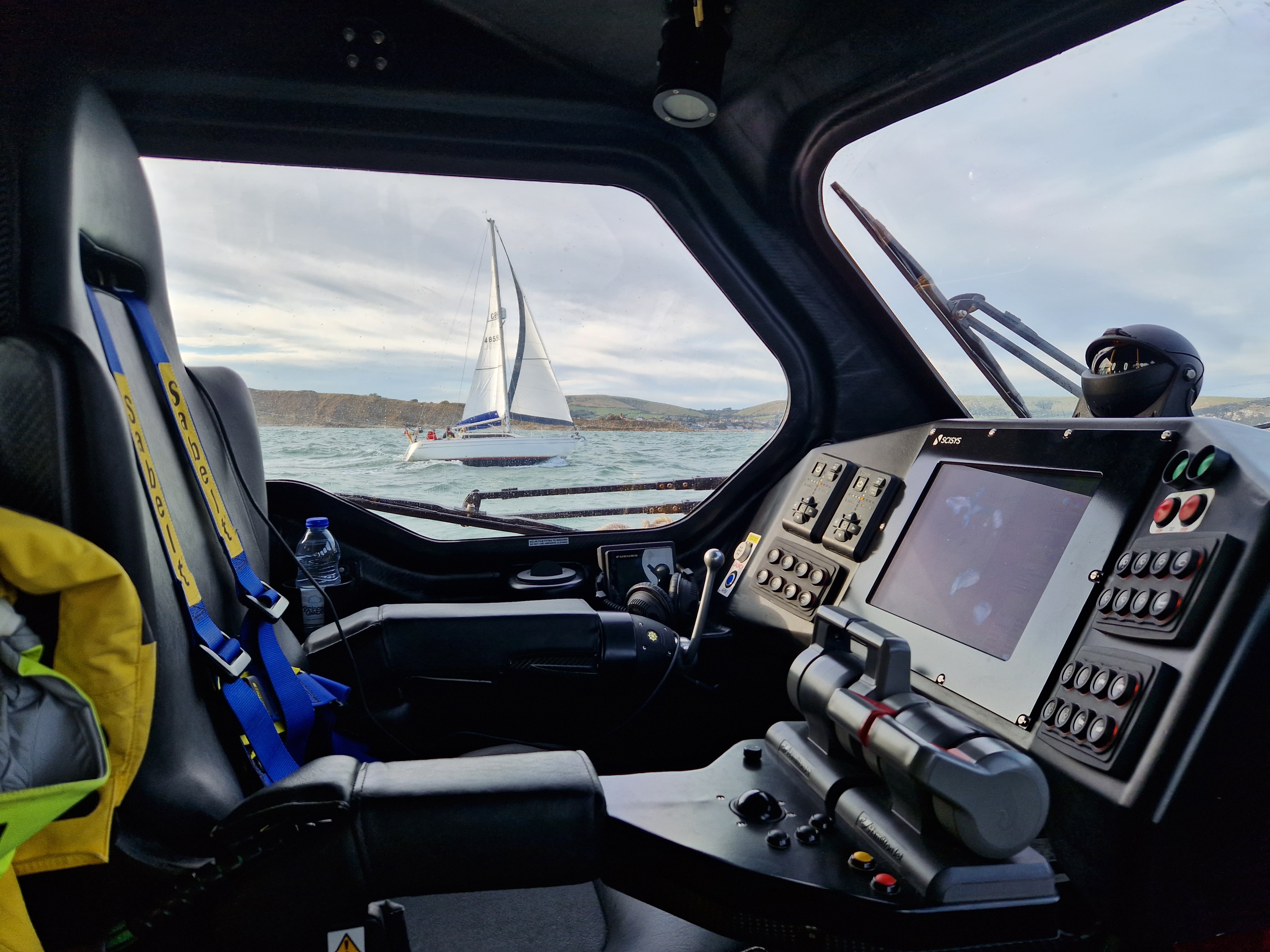 Swanage all-weather lifeboat escorting a yacht across Durlston Bay