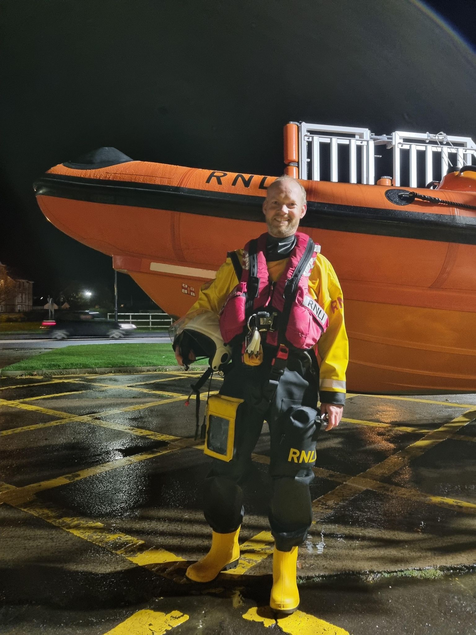 Gordon Kennedy standing with lifeboat