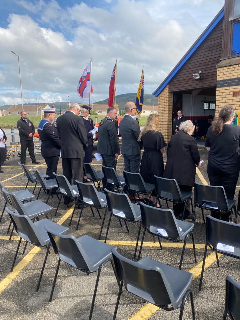 Local dignitaries stand in honour of the fallen