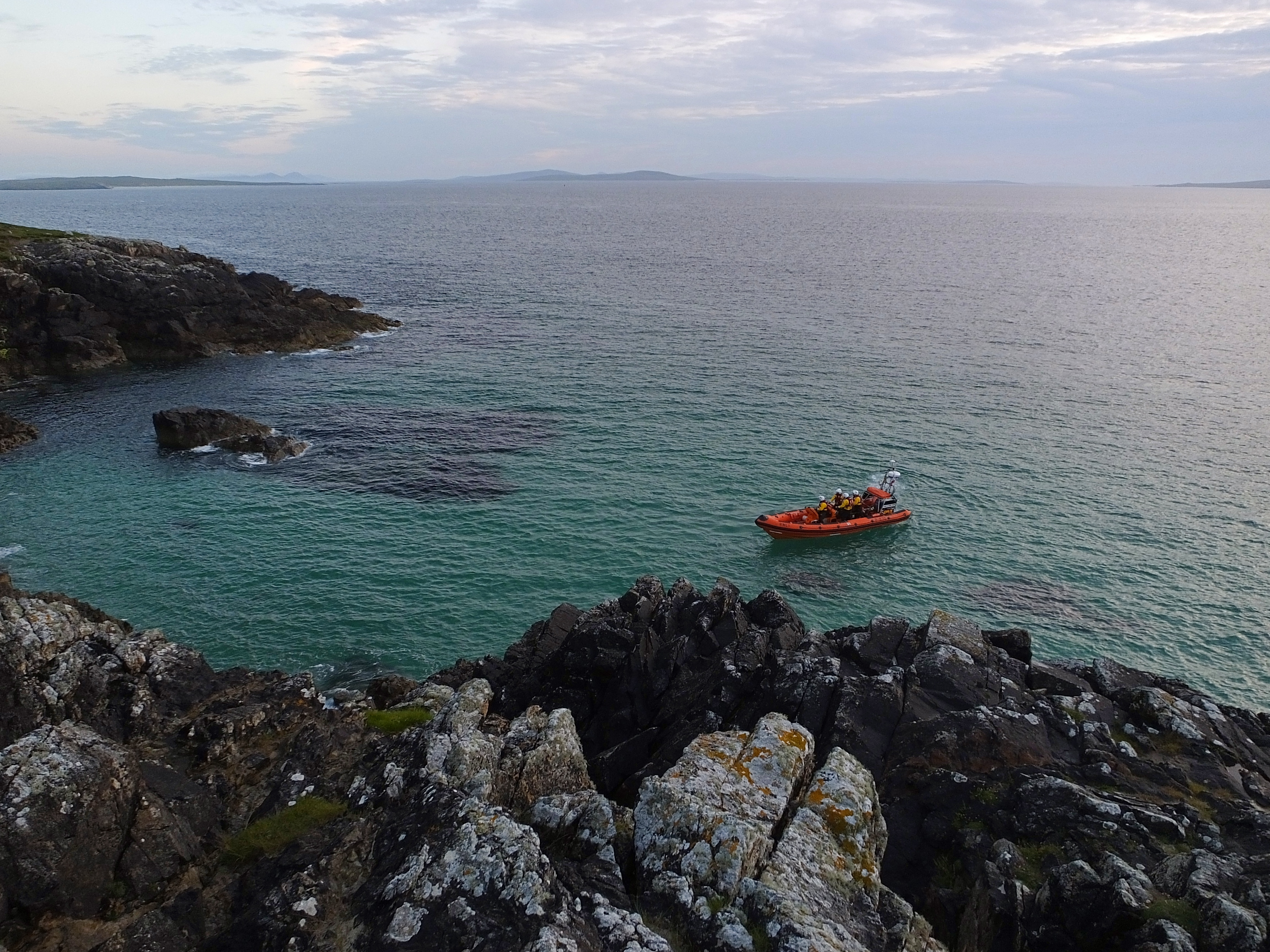 Atlantic 85 lifeboat at sea, close to rocky shore