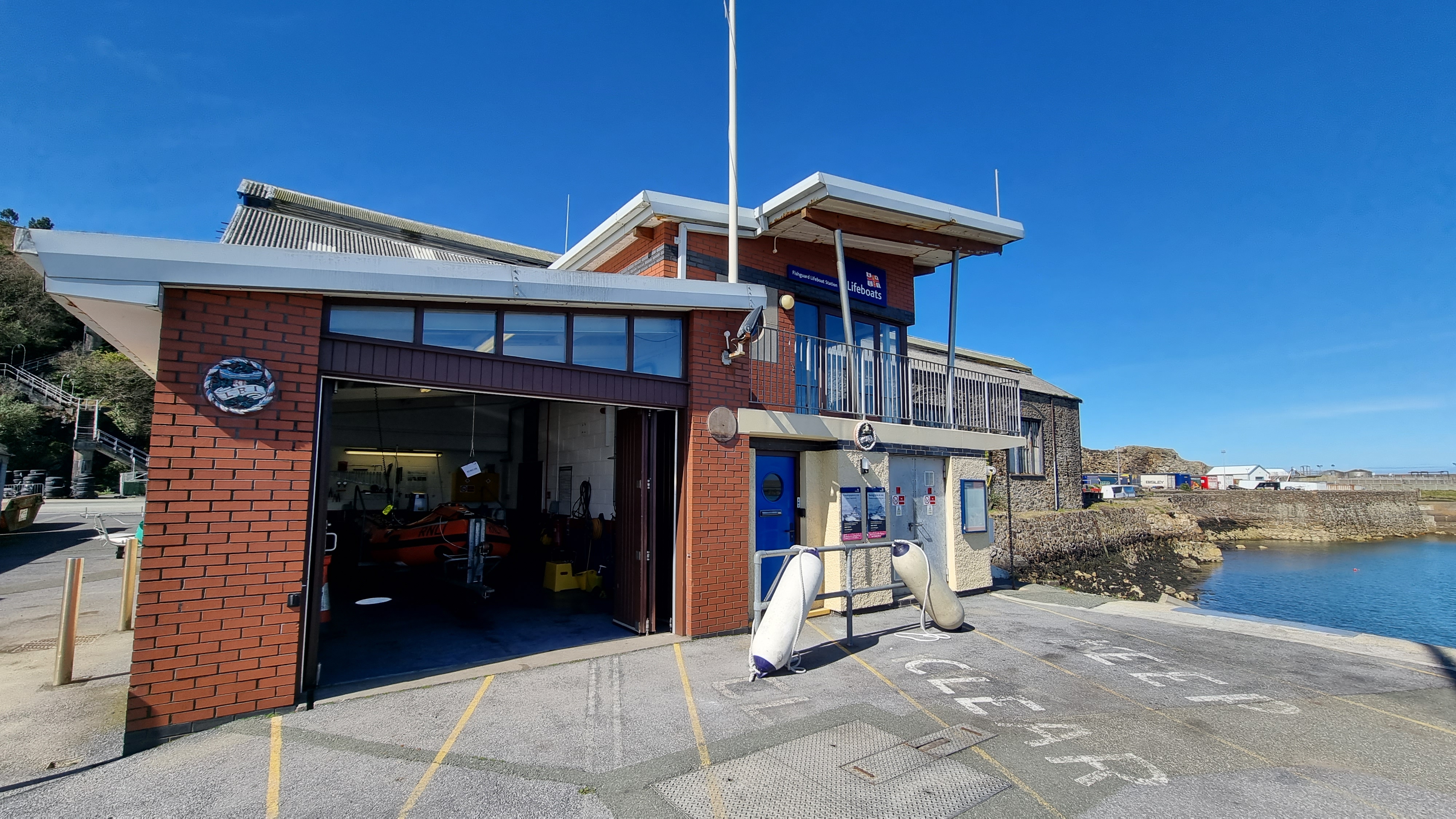 RNLI Fishguard Station and D-class inshore lifeboat Edward Arthur Richardson housed within following recovery.