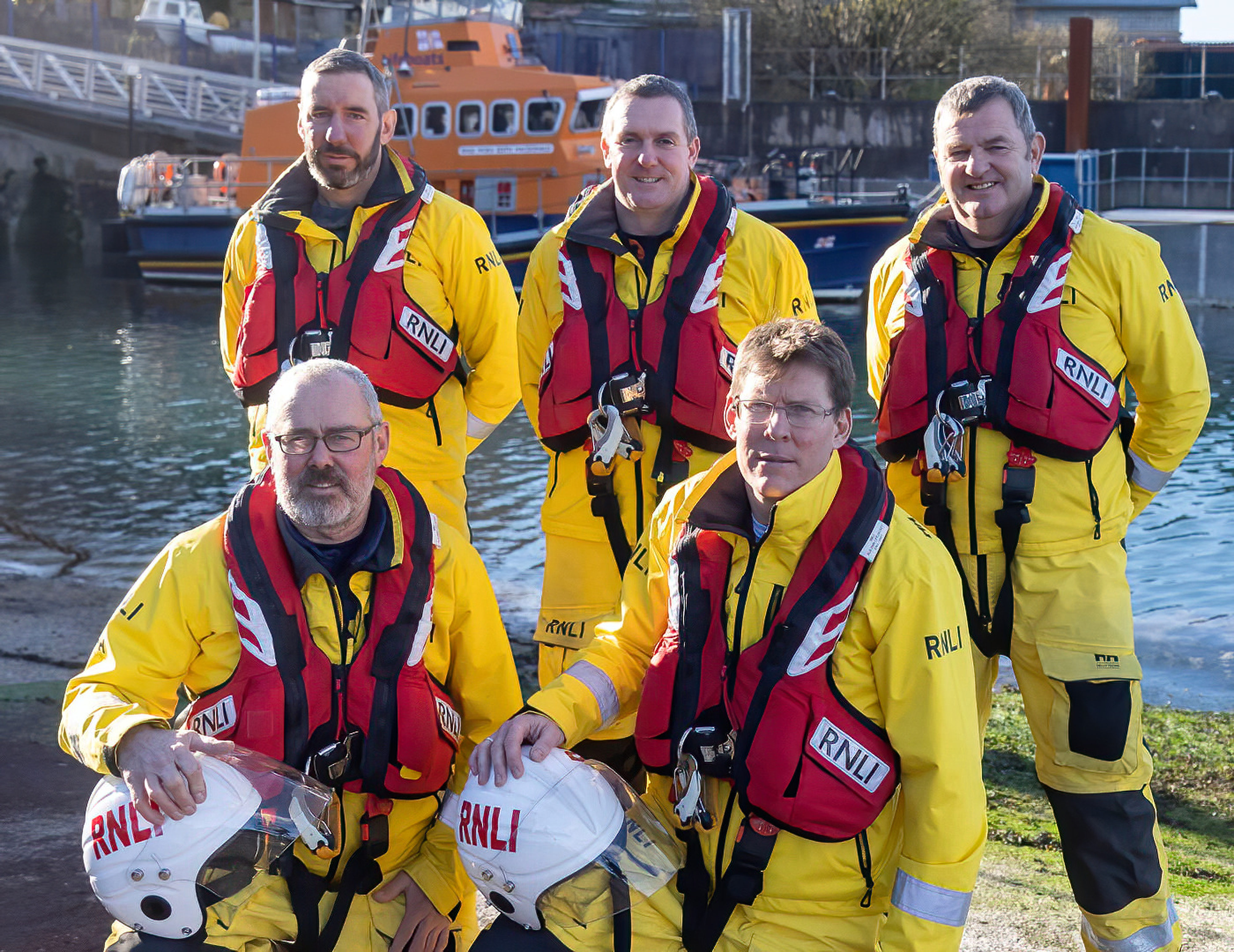 The five coxswains posing in front of Oban Lifeboat