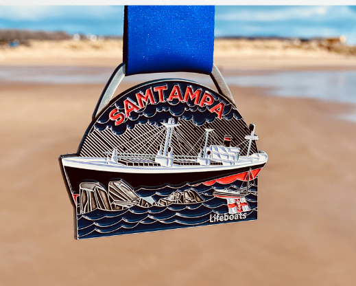 The medal participants received is a small semi circular medal with a relief picture of the Sampampa boat. It has a blue ribbon