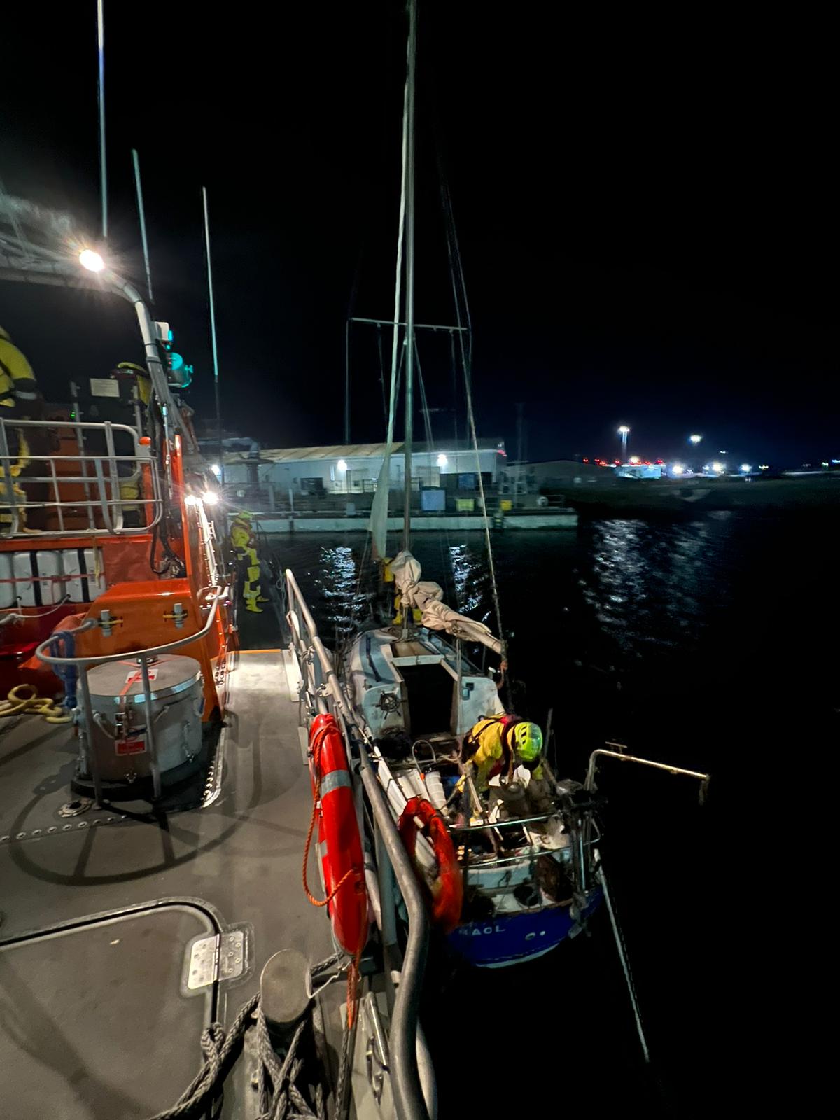 Casualty Yacht Alongside Barrow Lifeboat in Barrow Docks