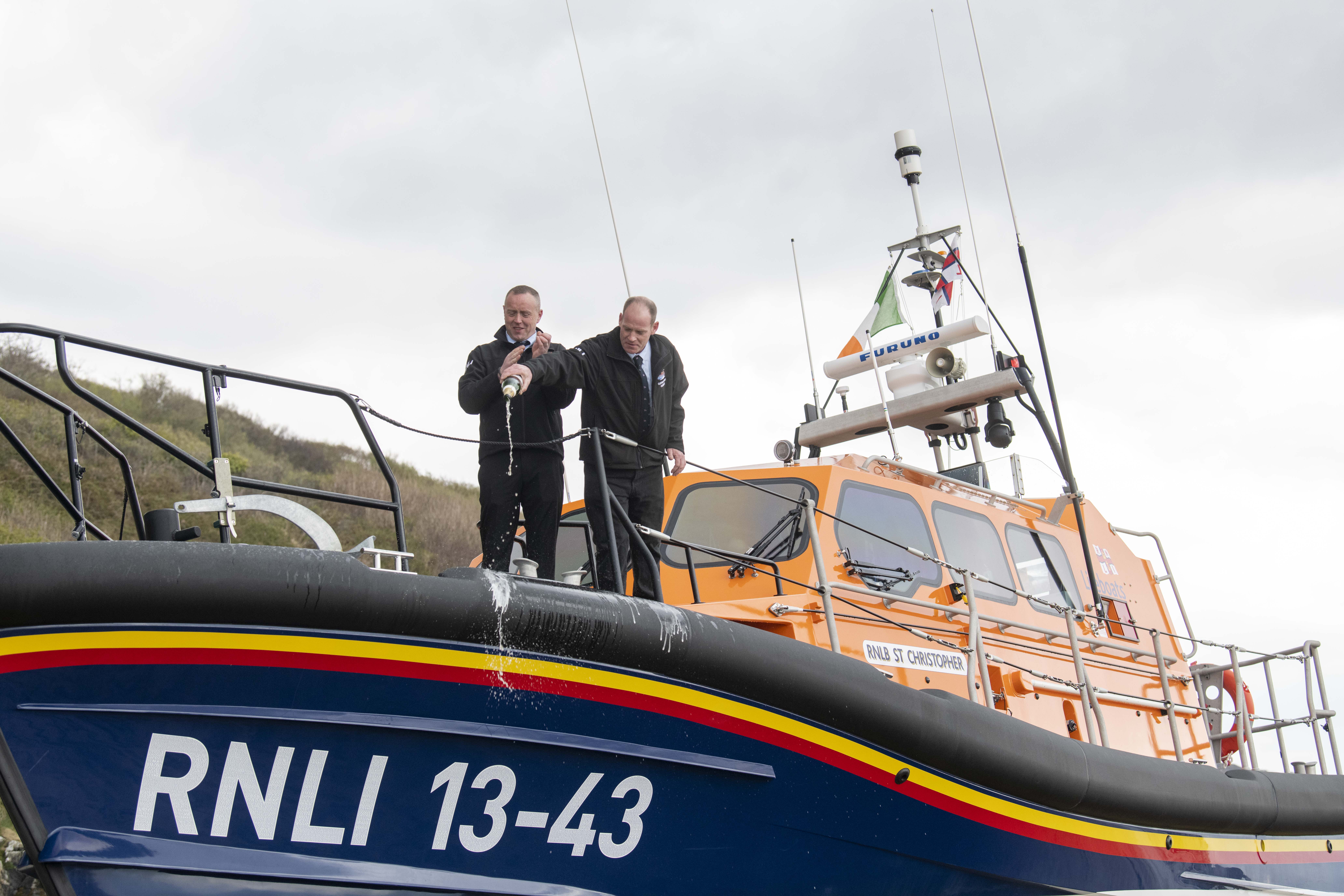 Clifden RNLI Mechanic Joe Acton with Coxswain James Mullen pour champagne on naming of St Christopher