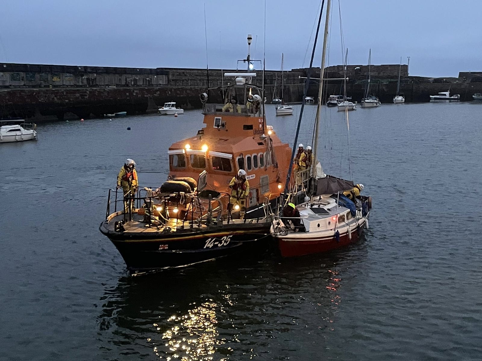 Photo shows Dunbar's all-weather Trent lifeboat alongside the casualty vessel yacht in Dunbar Harbour as they are about to berth.