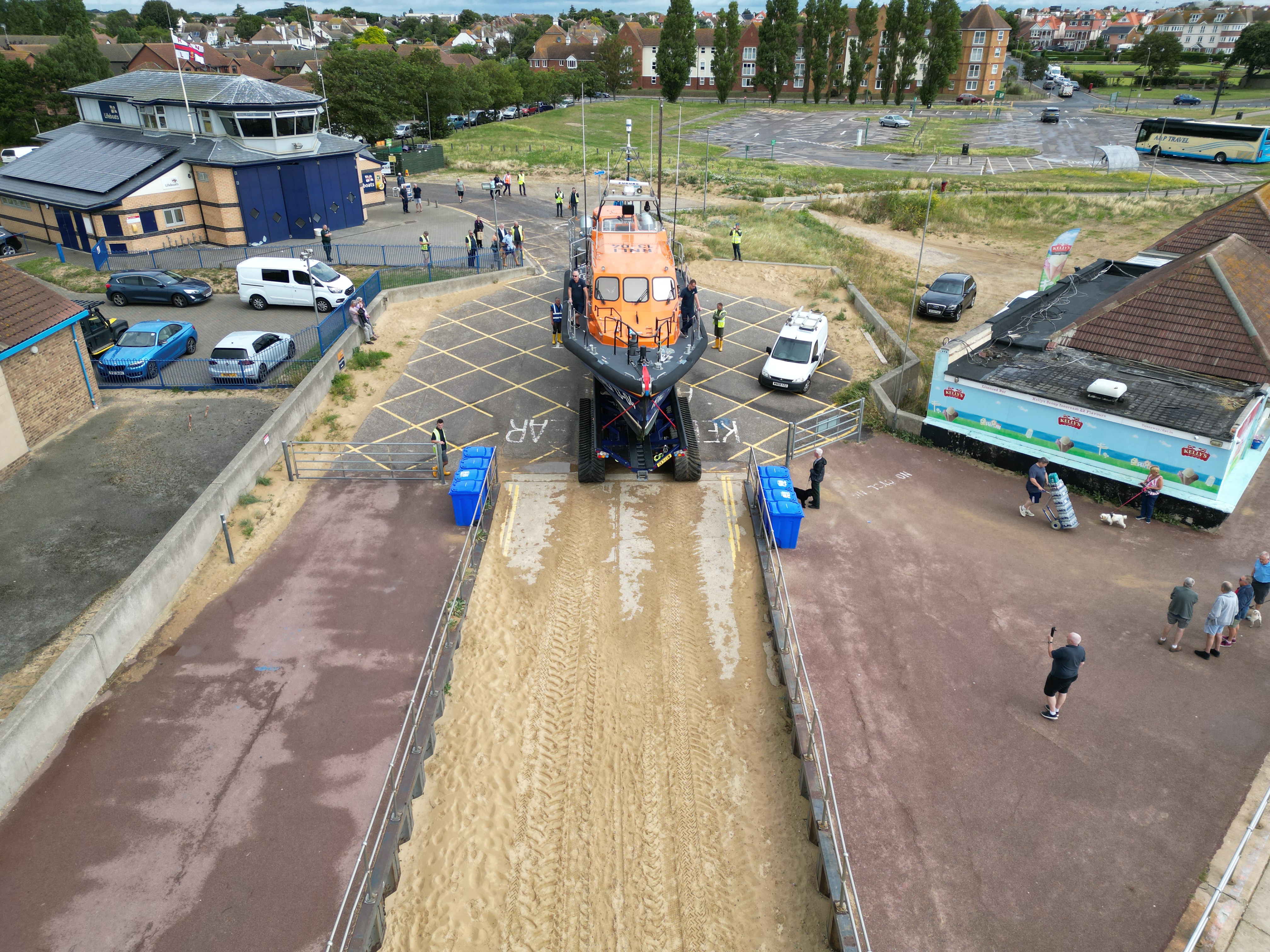 RNLI staff and volunteers trialling the Shannon at the beach at Clacton. This image shows the boat from above being pulled by tractor onto the beach