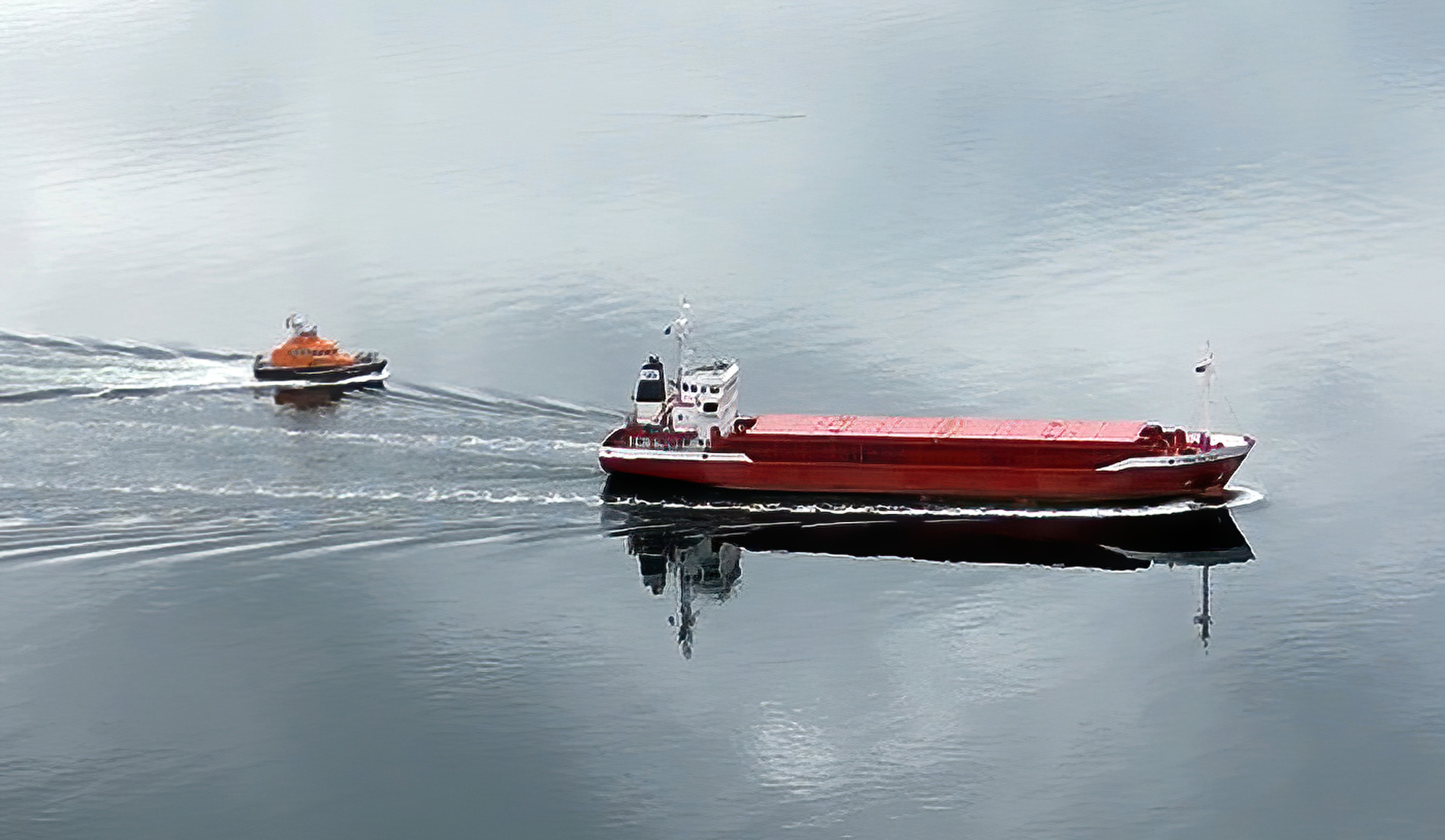 A drone image of the 64 metre cargo vessel being escorted to safety by the Oban lifeboat.