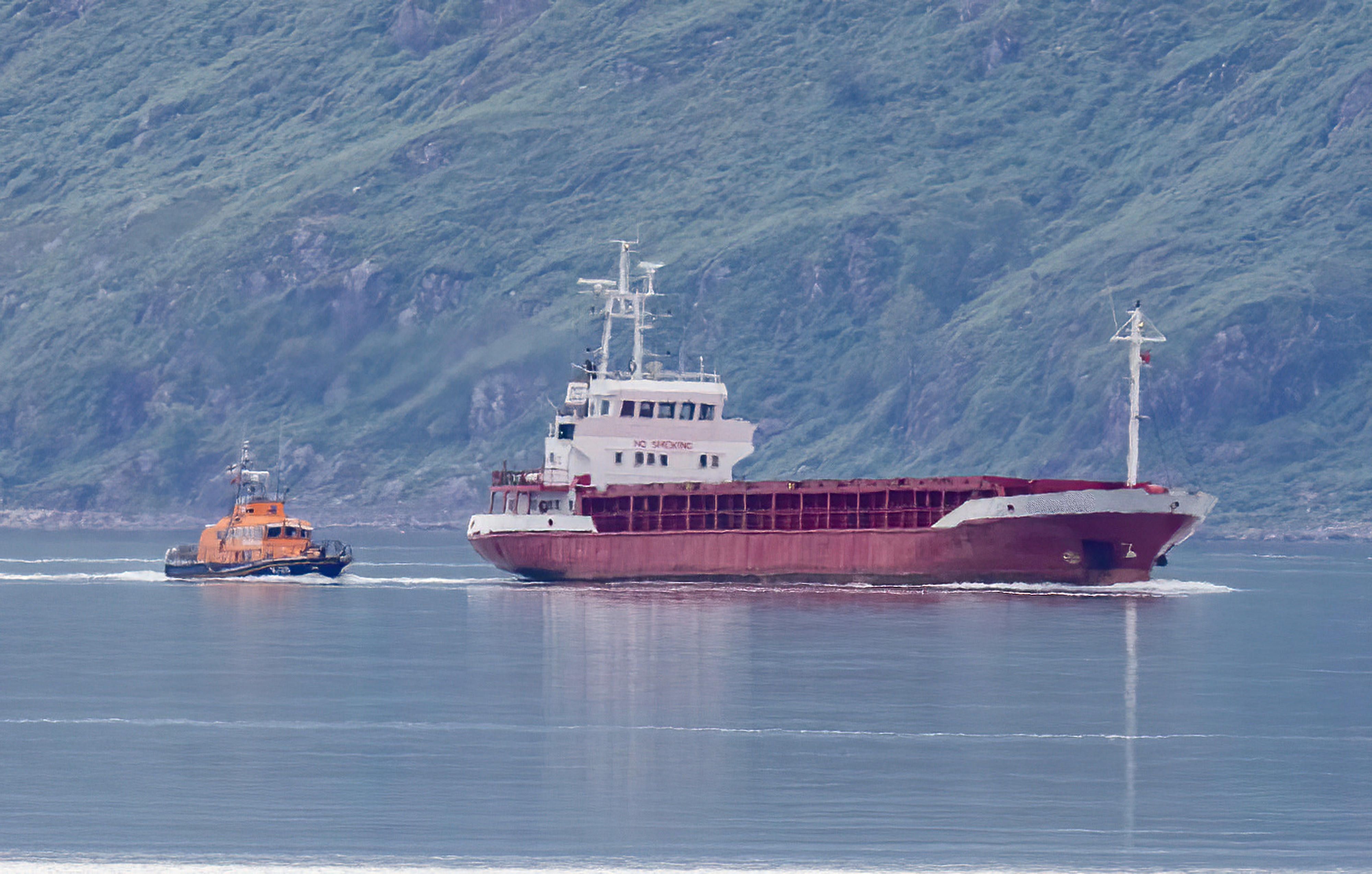 An image taken from the land of the 64 metre cargo vessel being escorted to safety by the Oban lifeboat.