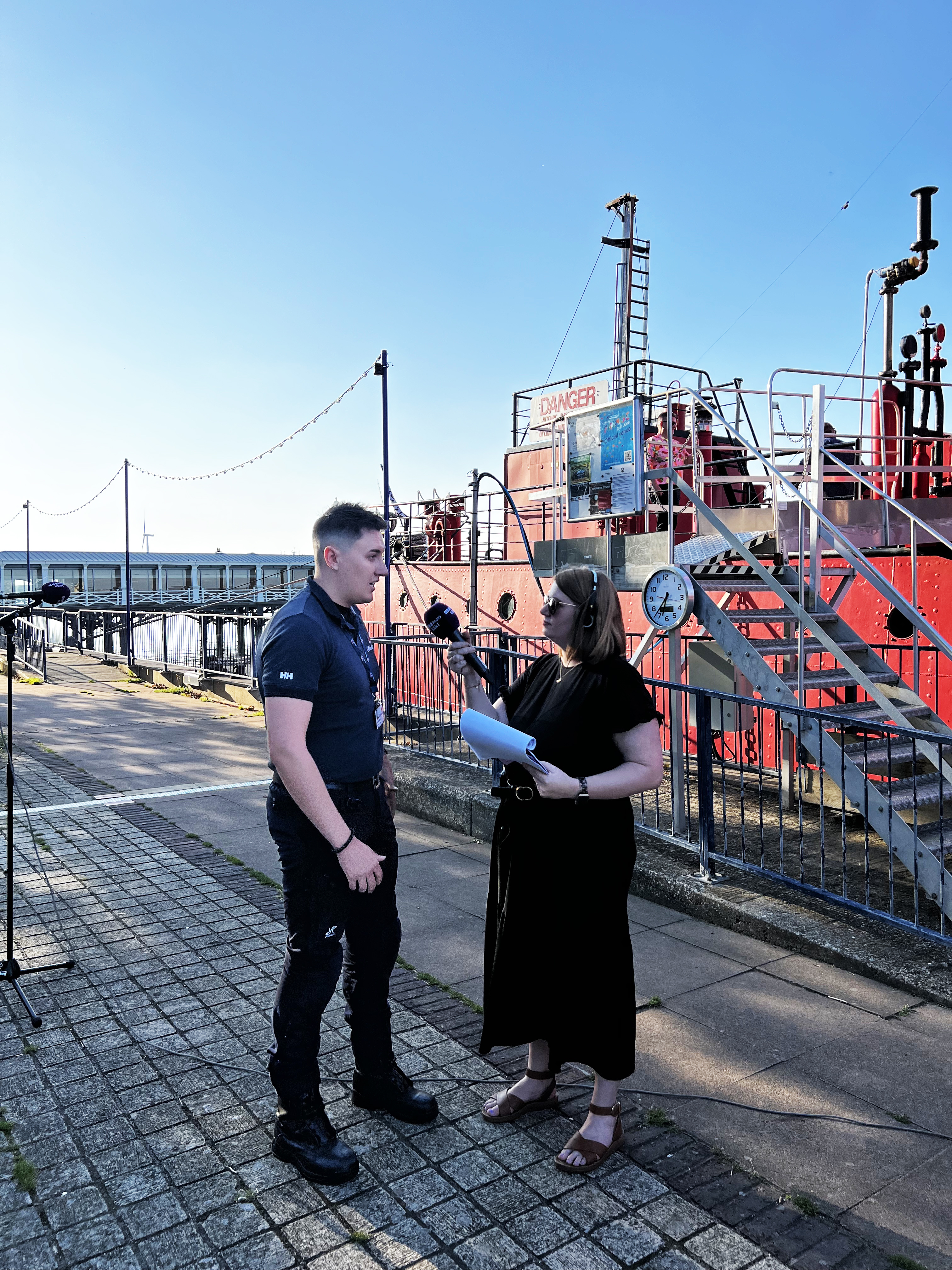 RNLI Thames Commander Liam Sidders and BBC Radio Kent's Sophie Sutton standing outside the LV21 red ship