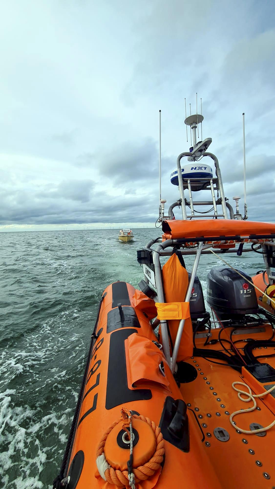 The angling dinghy is towed ashore by the Whitstable Atlantic 85 Lifeboat Lewisco on Friday evening.