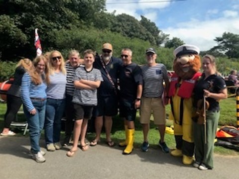 Members of the Bay Buccaneers with Steve Davies (Chair of the lifeboat station) of the Station and RNLI Mascot Stormey Sam (Claire Payne (Chair of the fundraising committee).