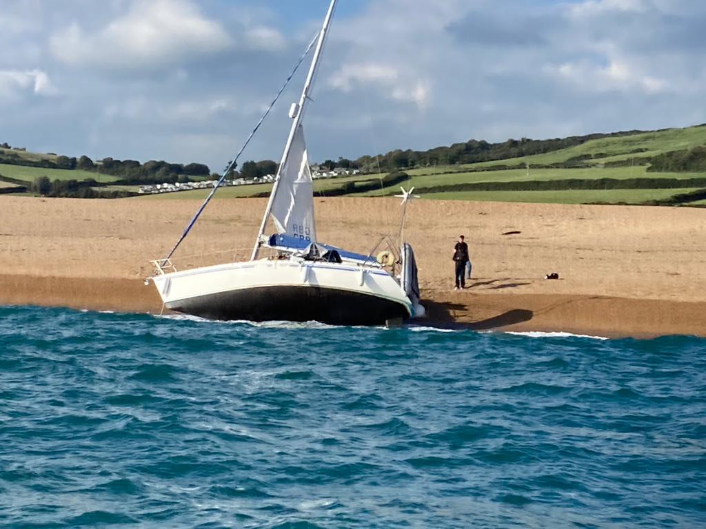 Yacht lying on its side on the beach