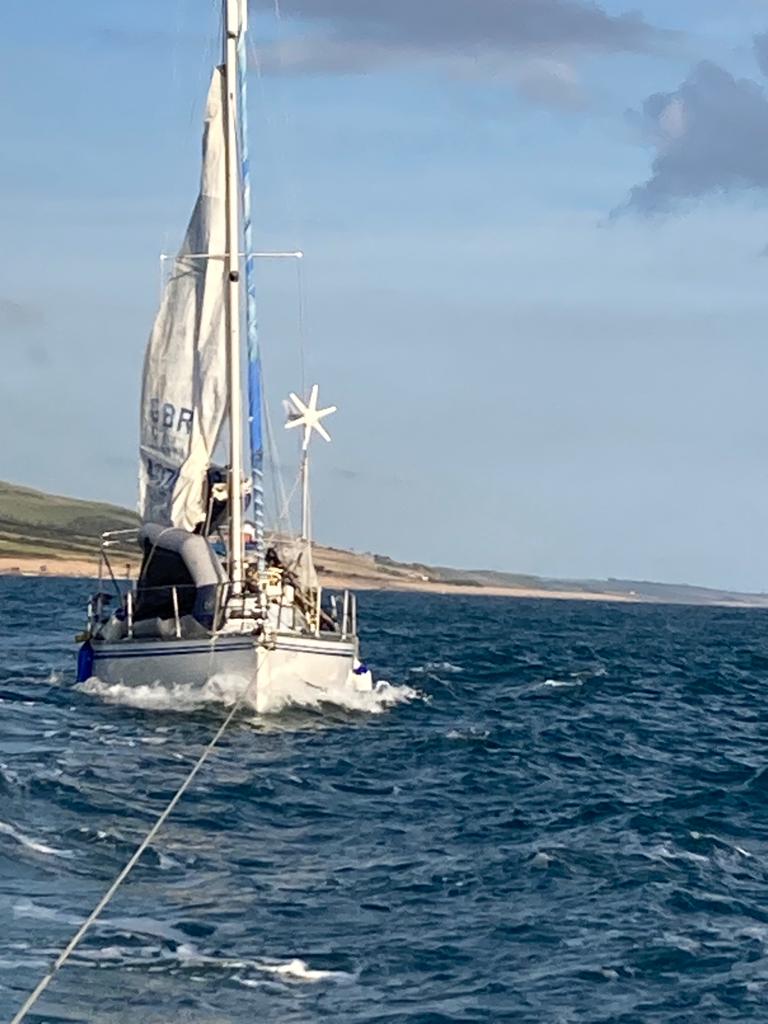 Beached yacht now refloated and under tow