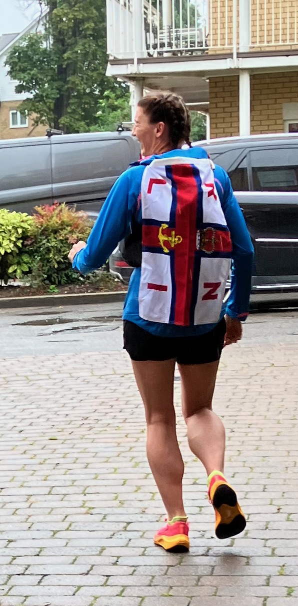 Emma is running off withh RNLI flag on her back