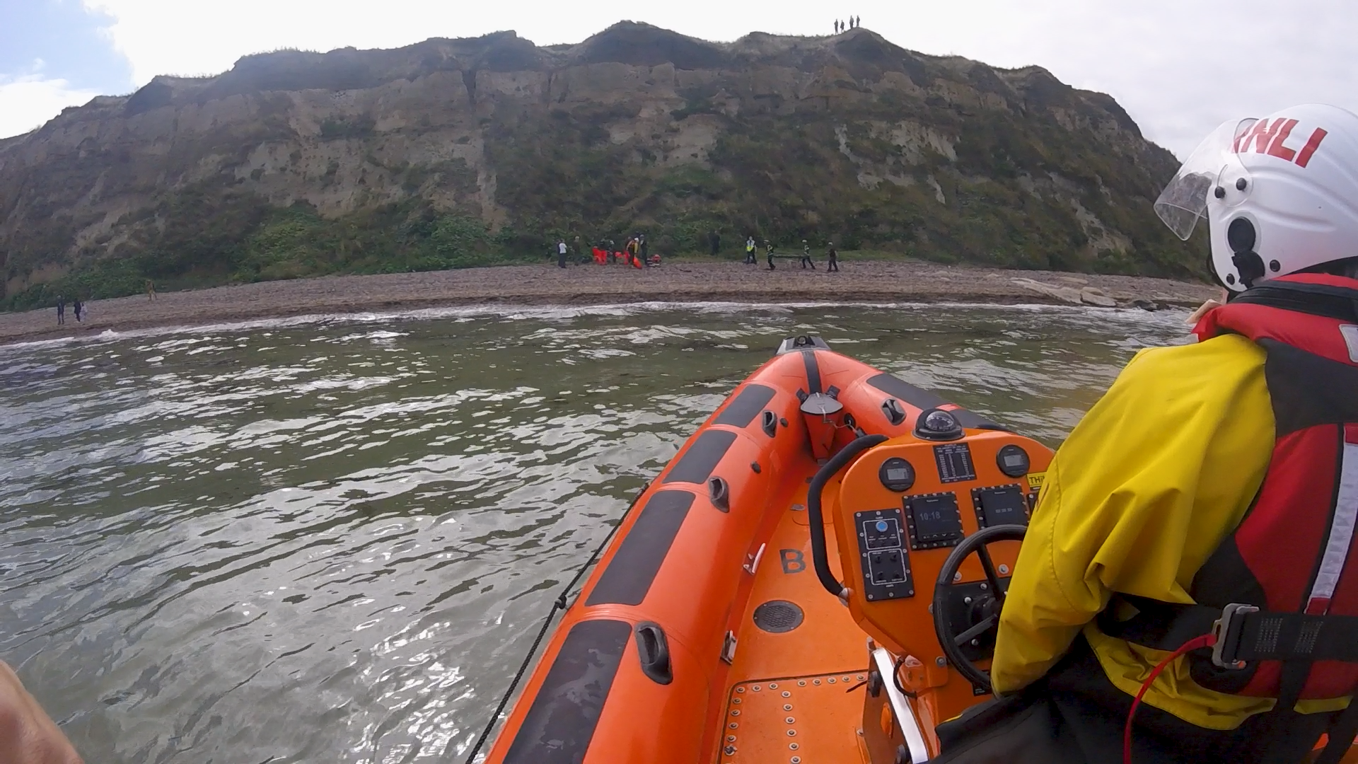 Whitstable Lifeboat approaches the cliffs at Bishopstone on Monday morning.