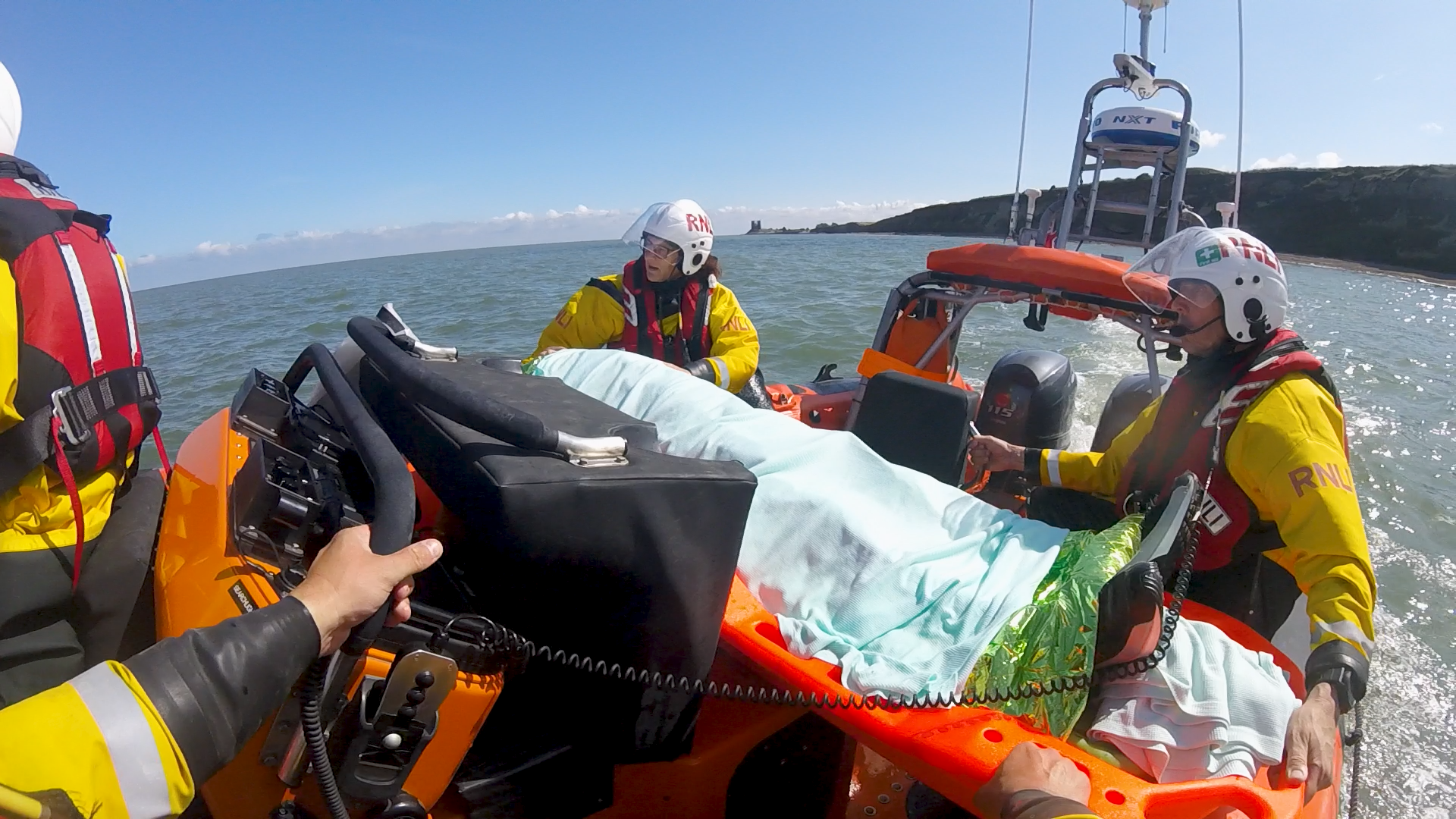 Lifeboat crew members care for the casualty as the lifeboat proceeds to Herne Bay.