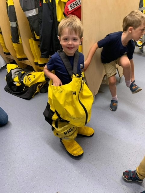 Otto and Rufus trying on Wells RNLI kit at station visit 