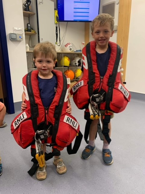 Otto and Rufus in RNLI lifejackets when they visited Wells RNLI for a station visit