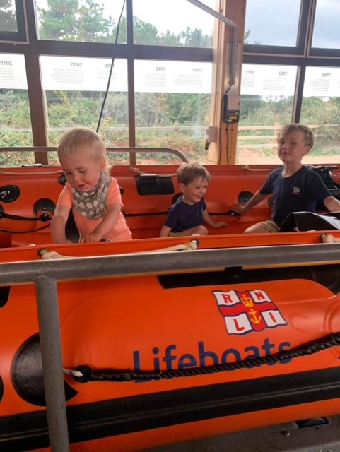 Station visit for Otto, Rufus and Casper. Sitting in D class lifeboat Peter Wilcox