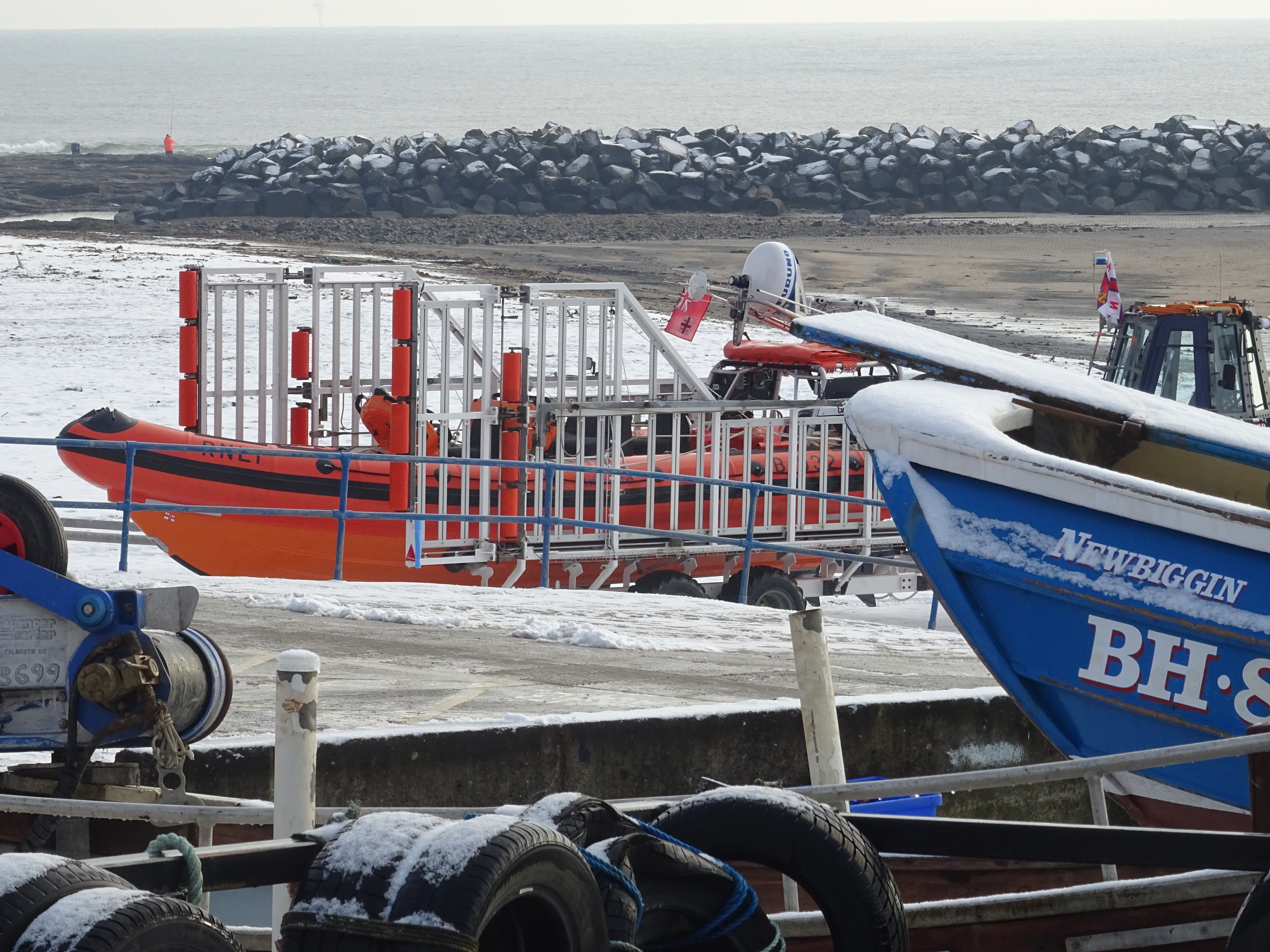 A snow covered seashore provides the event backdrop